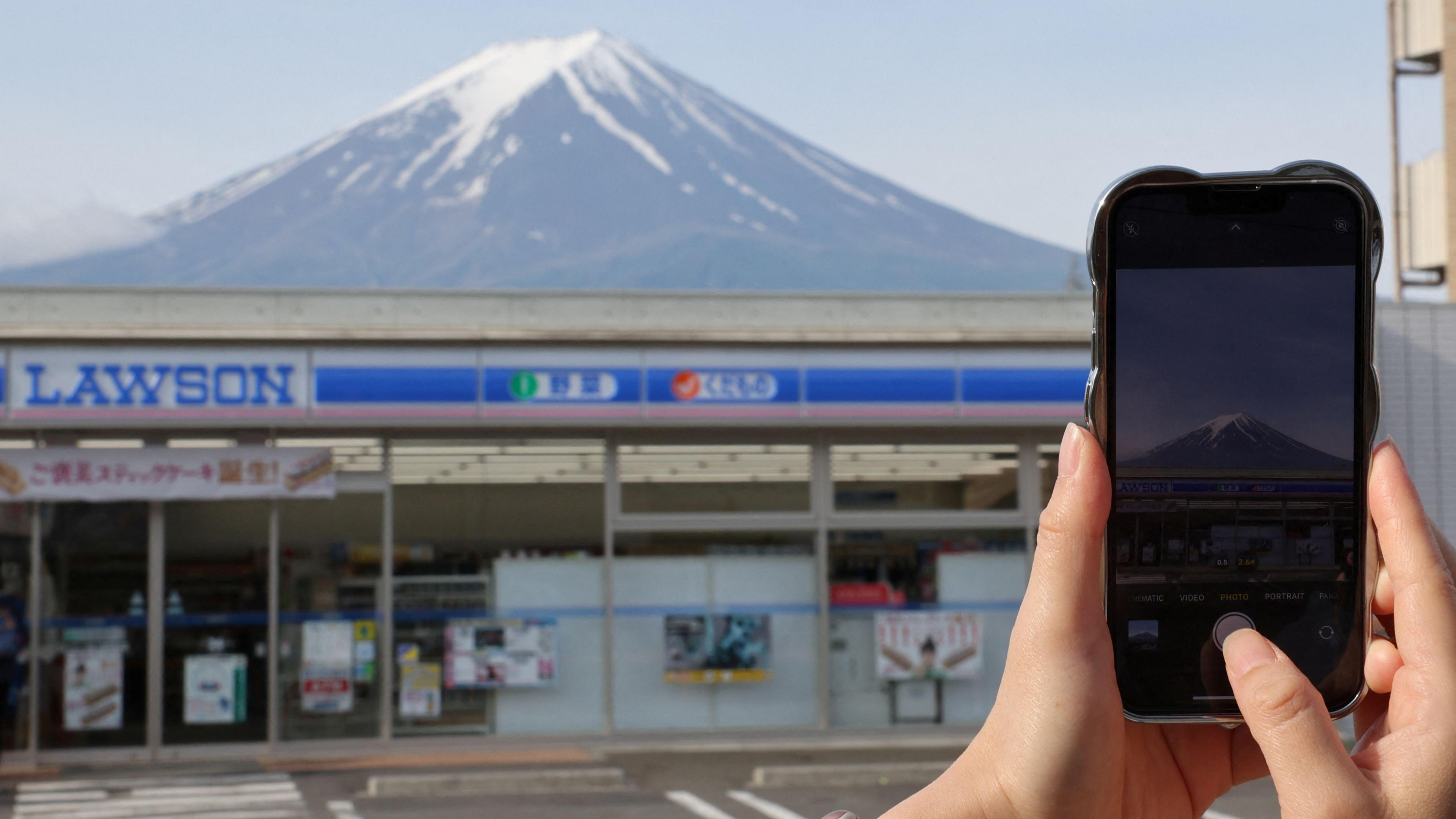 someone taking a photo of Fuji behind Lawsons