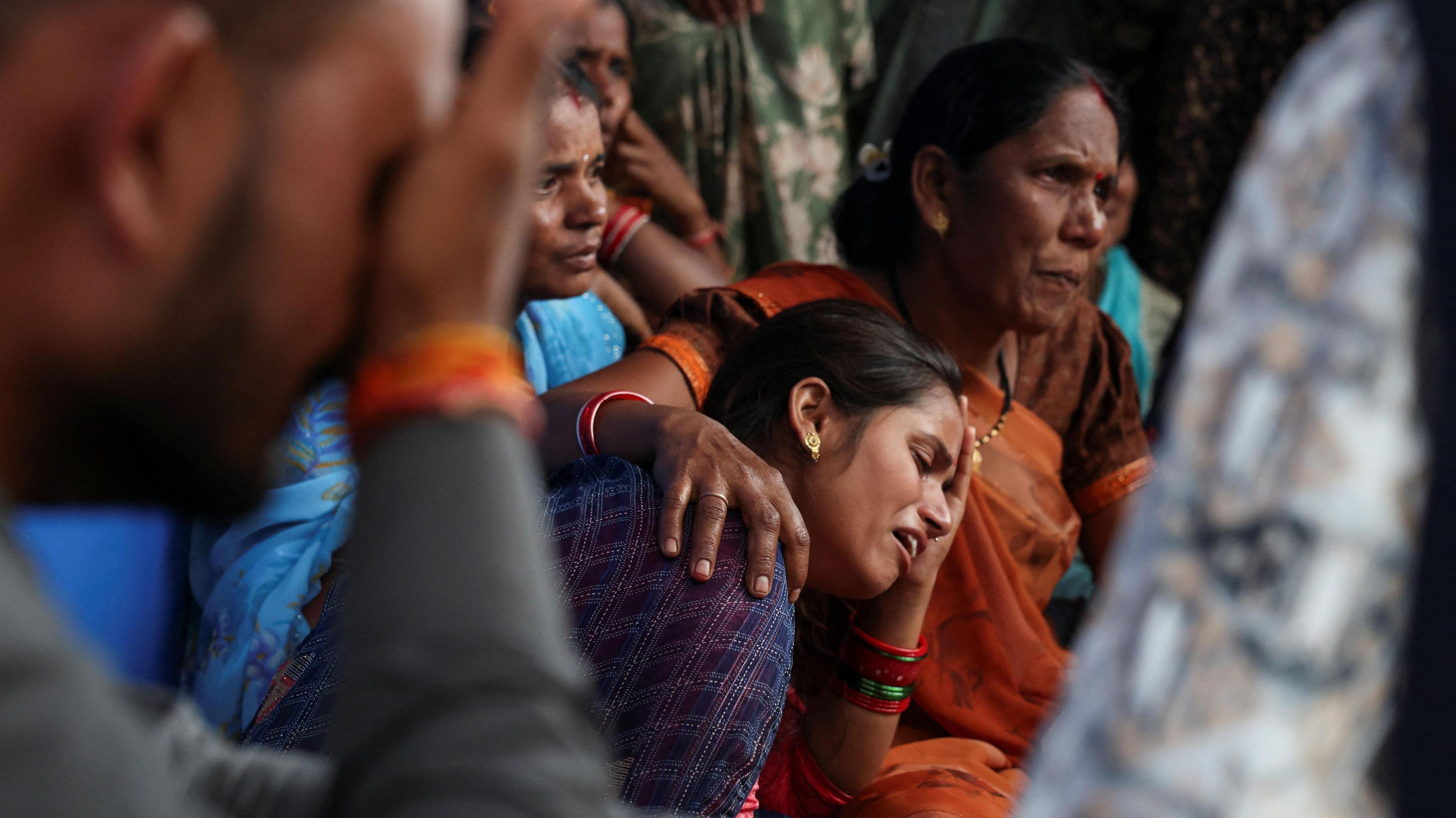 Reenu Suryavanshi mourns in front of her three-and-a-half-year-old child's body at their home in a village in Parasia, India, October 9, 2025. The child died after being admitted to a hospital following the consumption of Coldrif cough syrup, which has been linked to the deaths of several children.