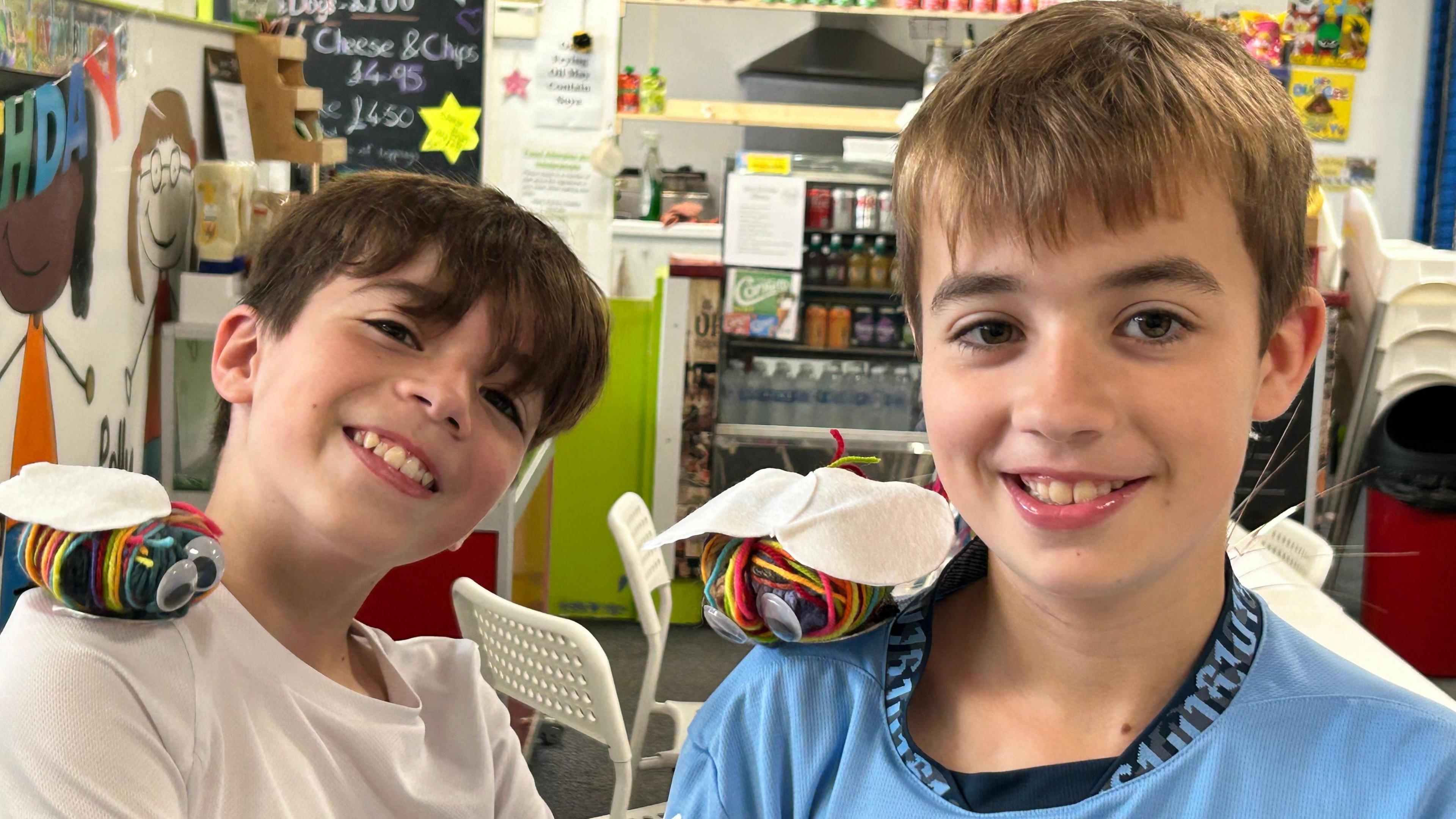 Twins Alex and Thomas show off the bees they have made for the Pride Parade
