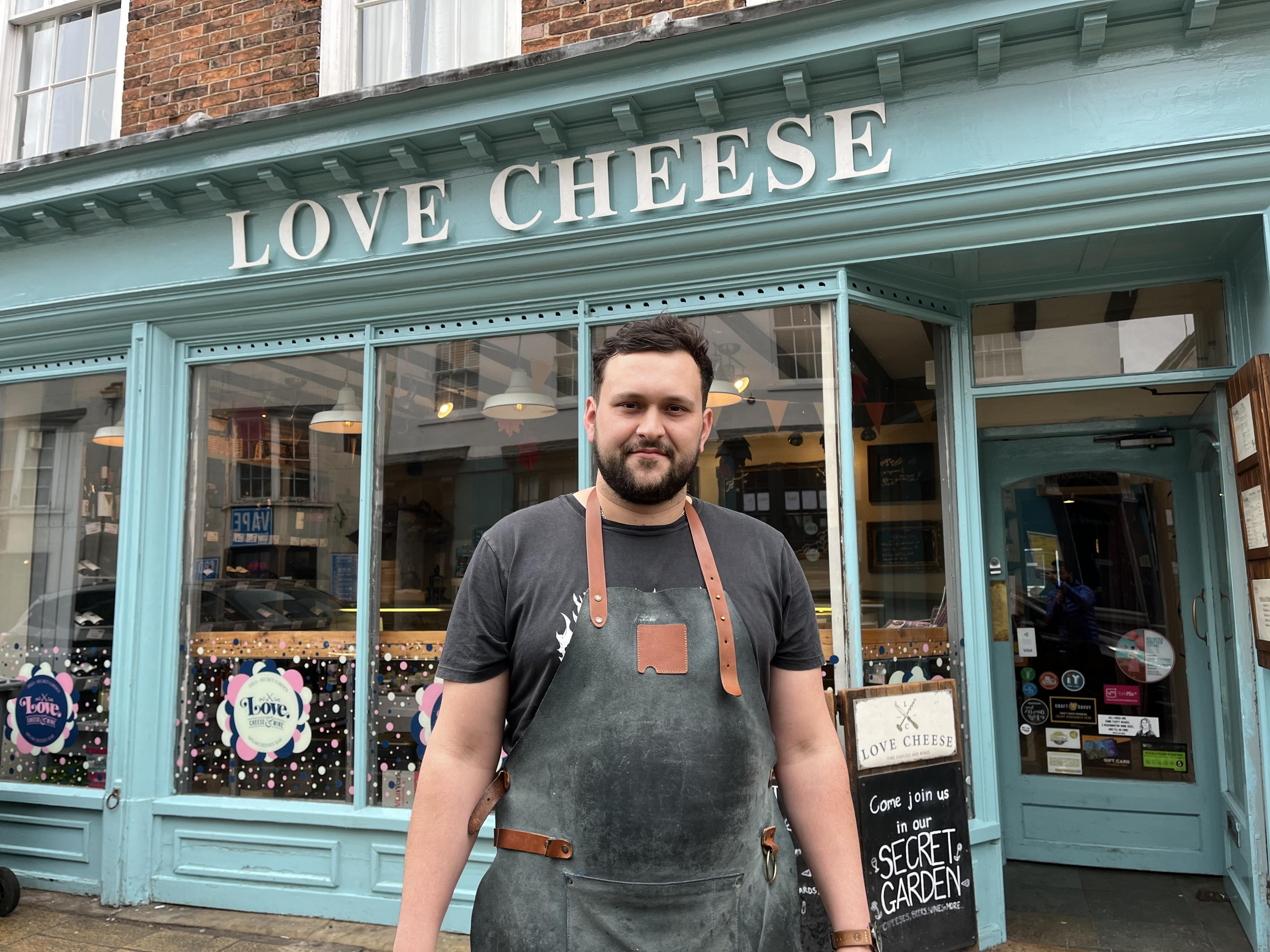 Man stood in front of cheese shop