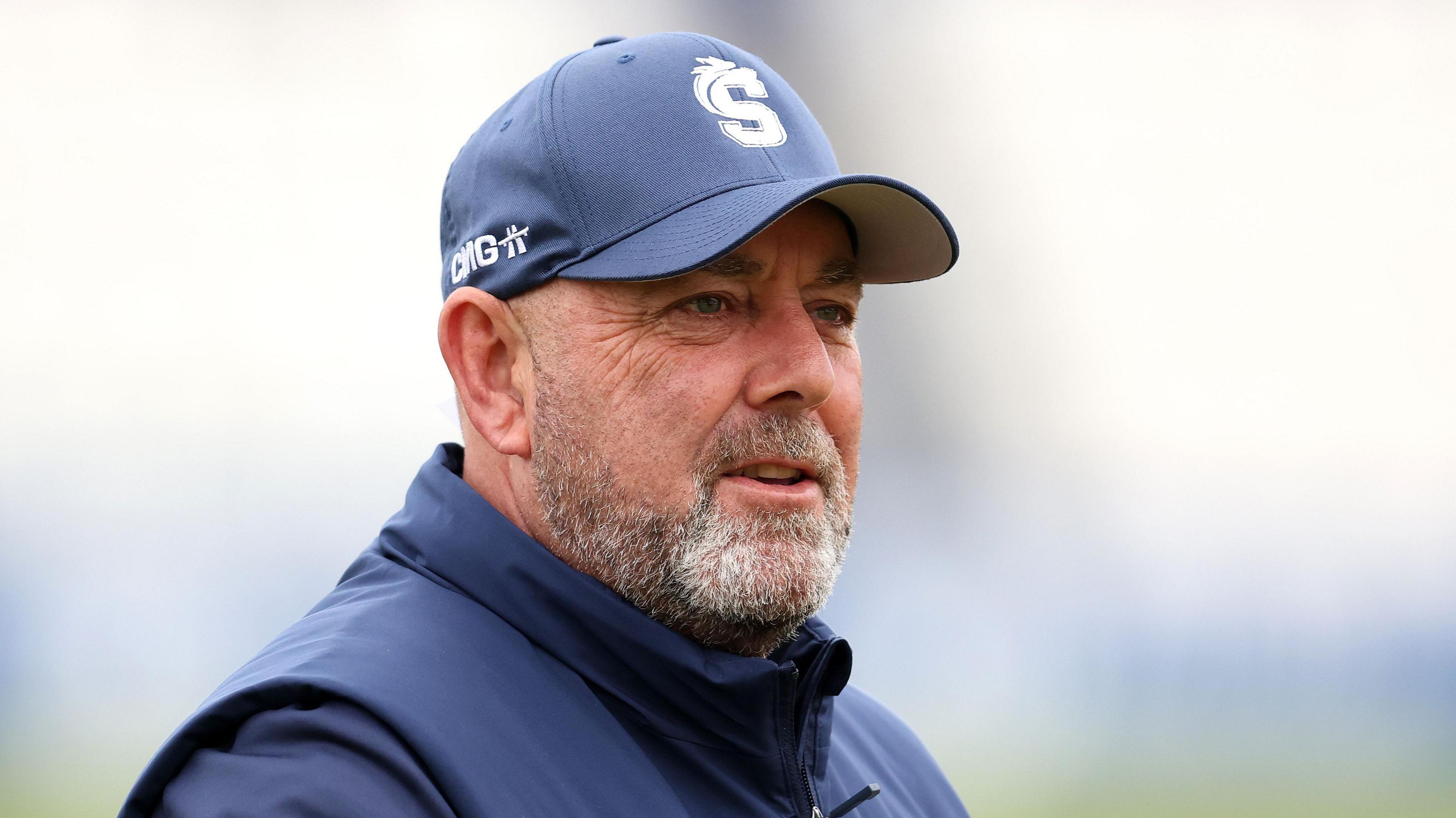 Northamptonshire head coach Darren Lehmann. He is wearing a navy baseball cap with the Northamptonshire Steelbacks logo on the front.