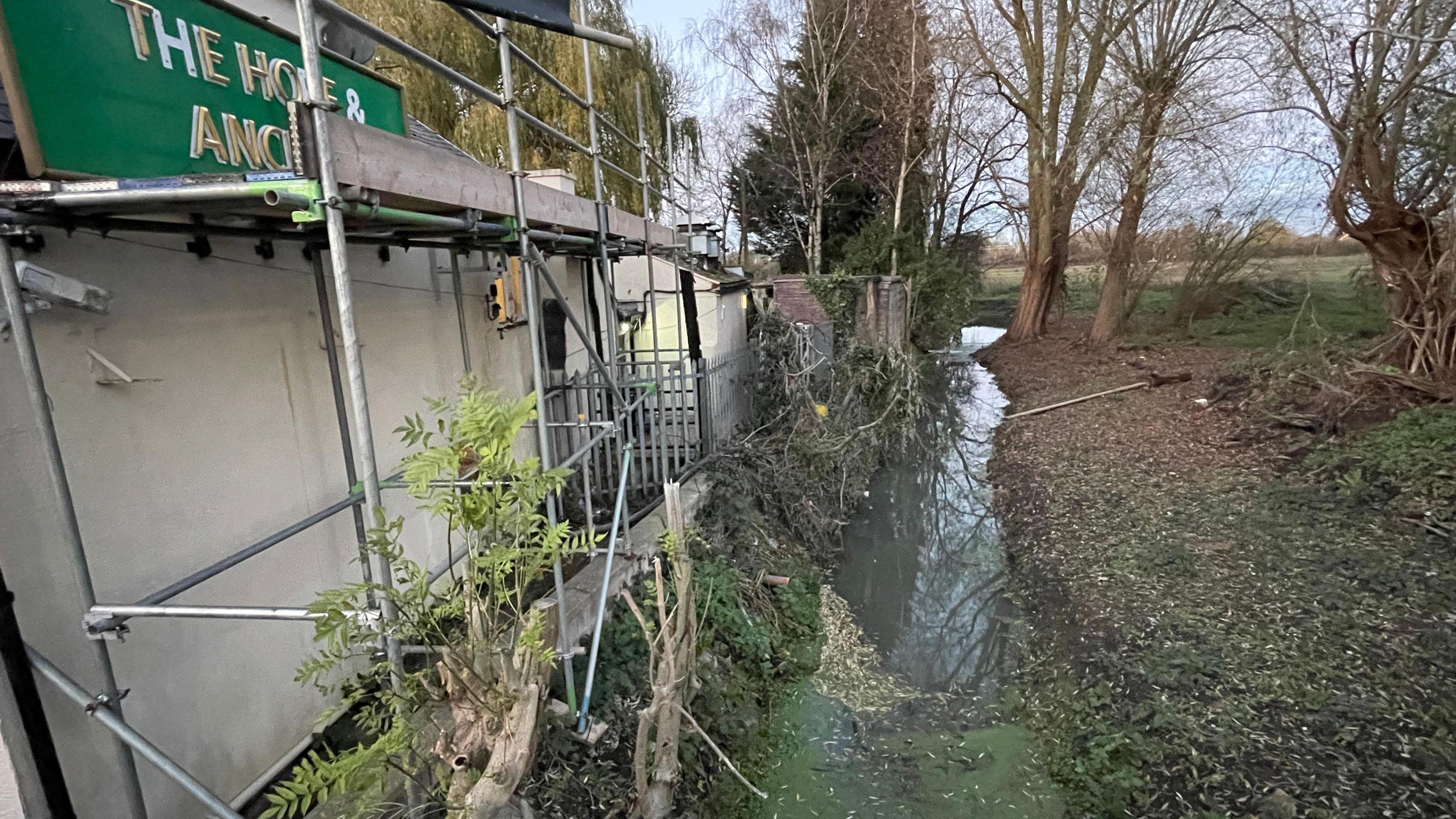 A soggy trench running along the perimeter of the pub site