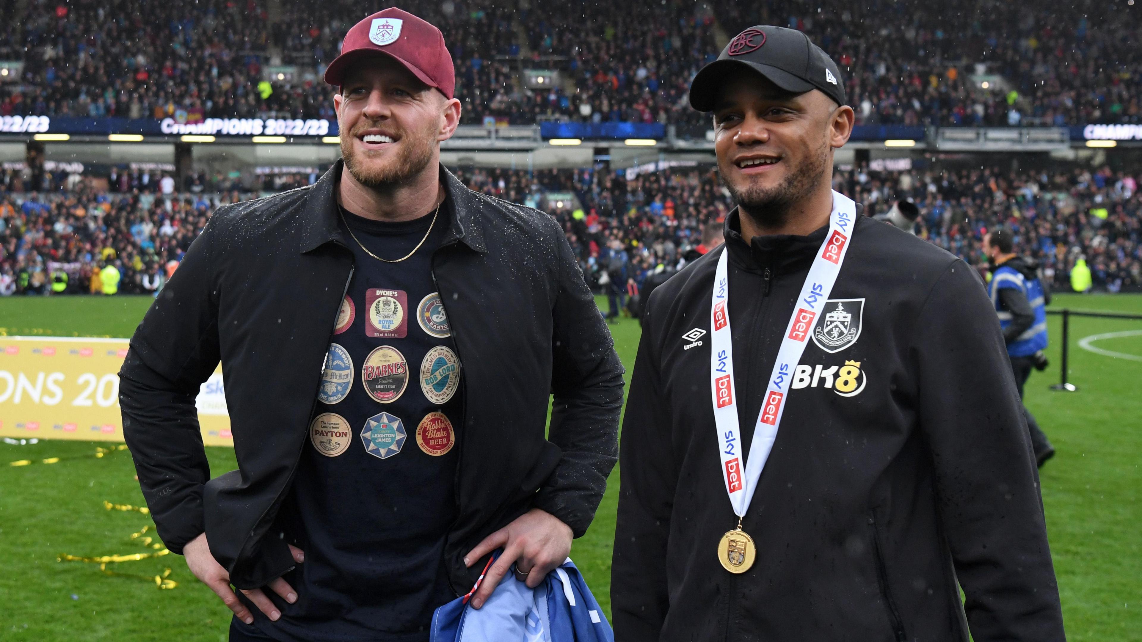 Vincent Kompany, then manager of Burnley, speaks with NFL legend and Burnley stakeholder JJ Watt