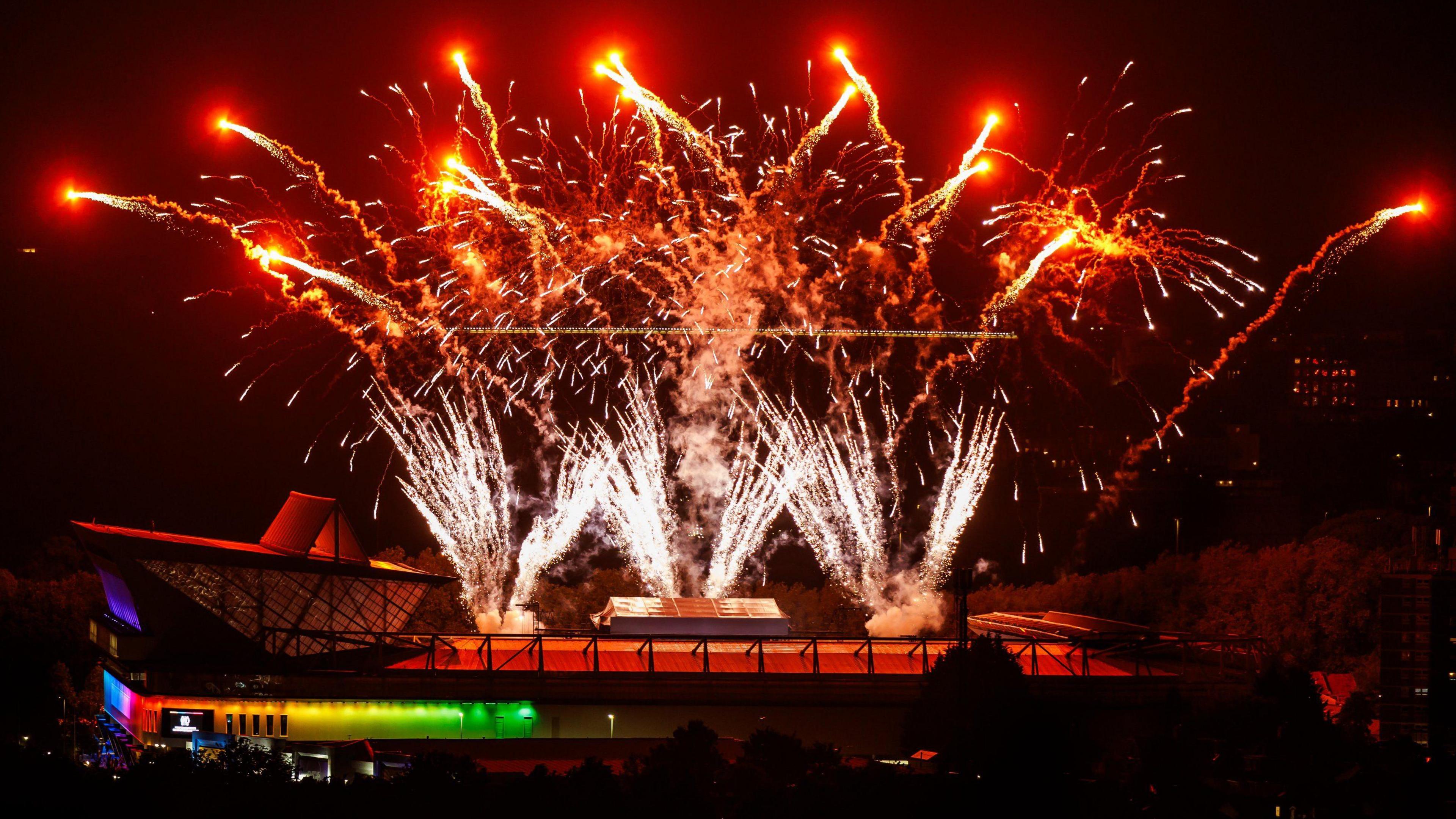 A huge fireworks display is visible over Ashton Gate Stadium in Bristol at the end of a Take That concert. The photo is taken at night with the external parts of the stands also illuminated.