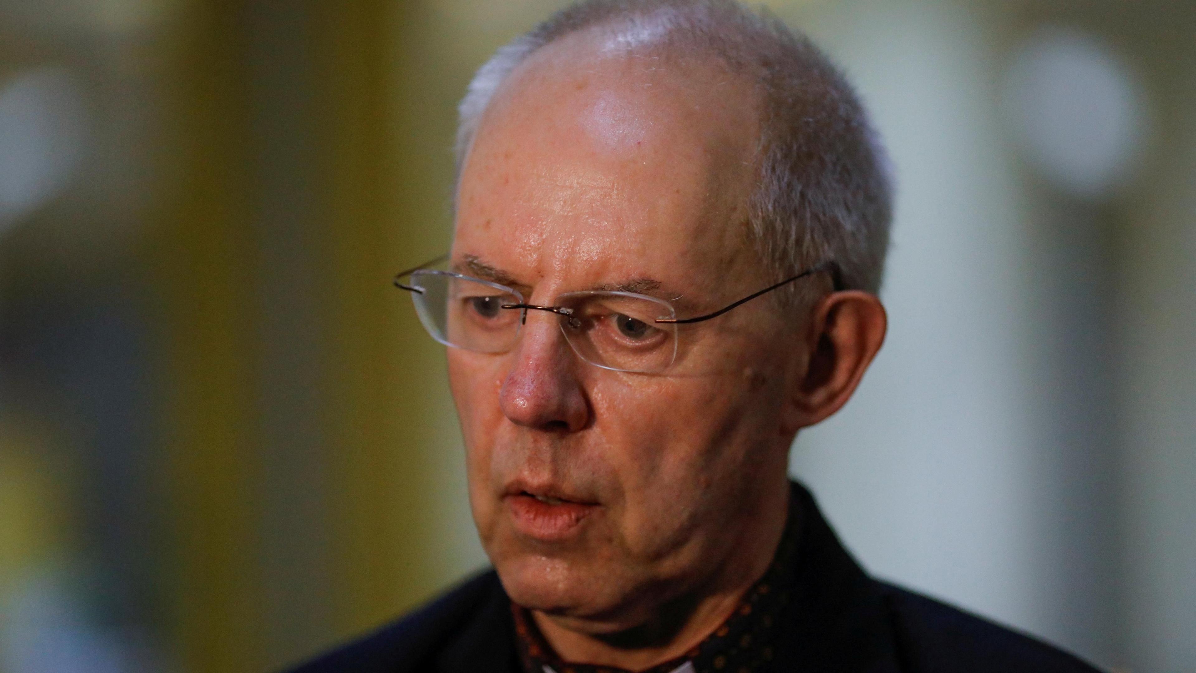 Justin Welby, wearing glasses and a dark robe