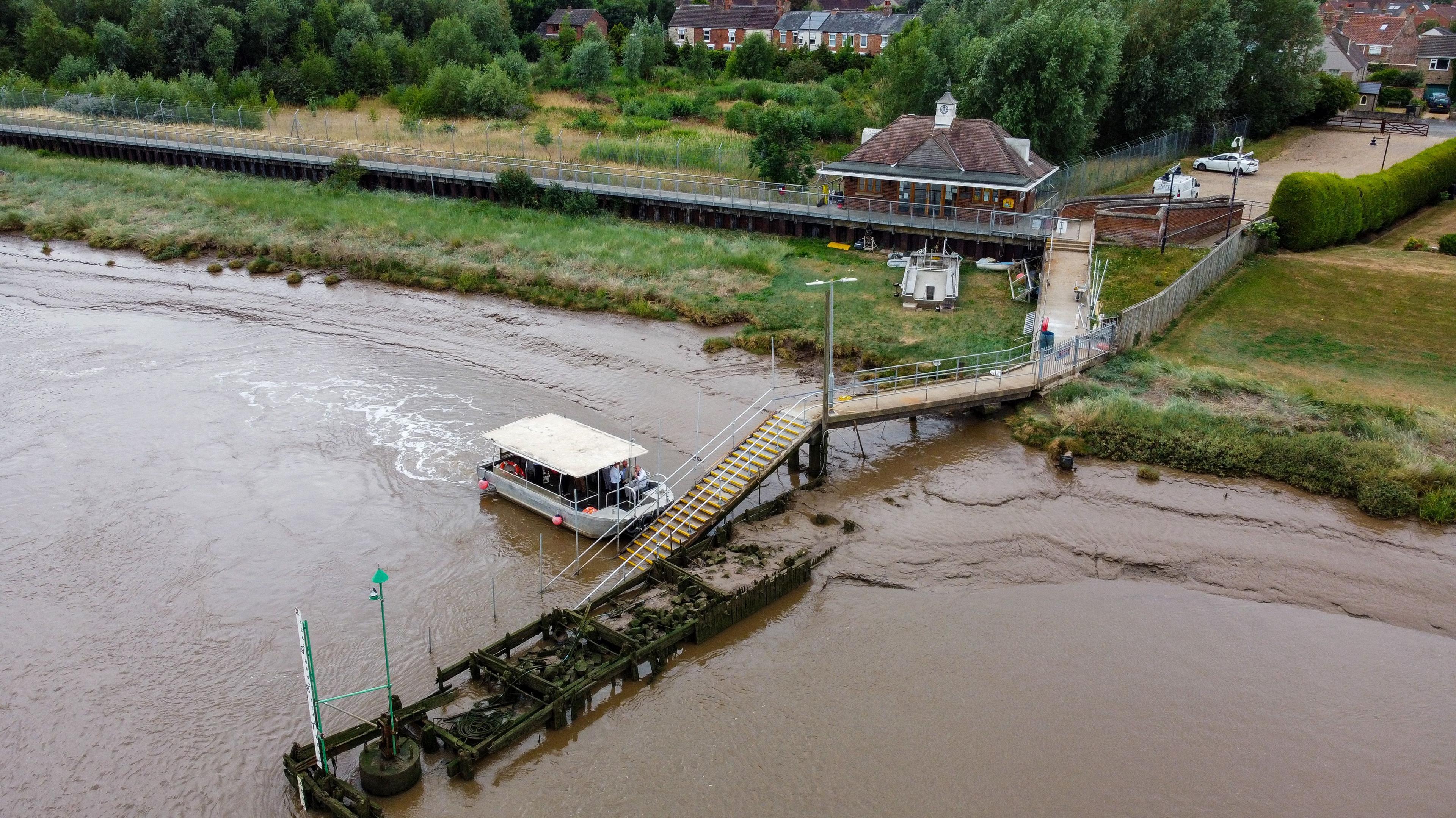 An aerial view of the King's Lynn ferry as it comes alongside the jetty on the West Lynn side of the River Great Ouse.