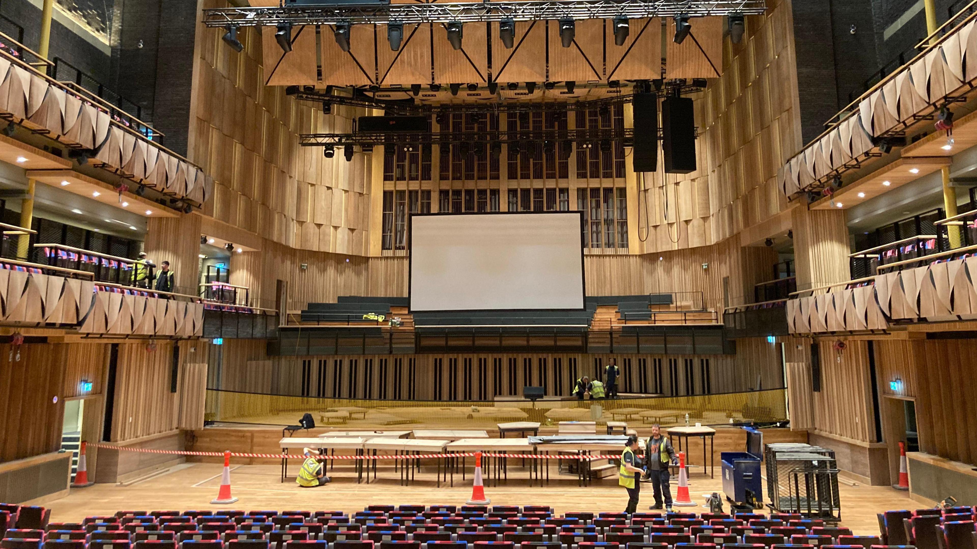 View of the Beacon Hall's stage with a few workers in hi-vis in the background