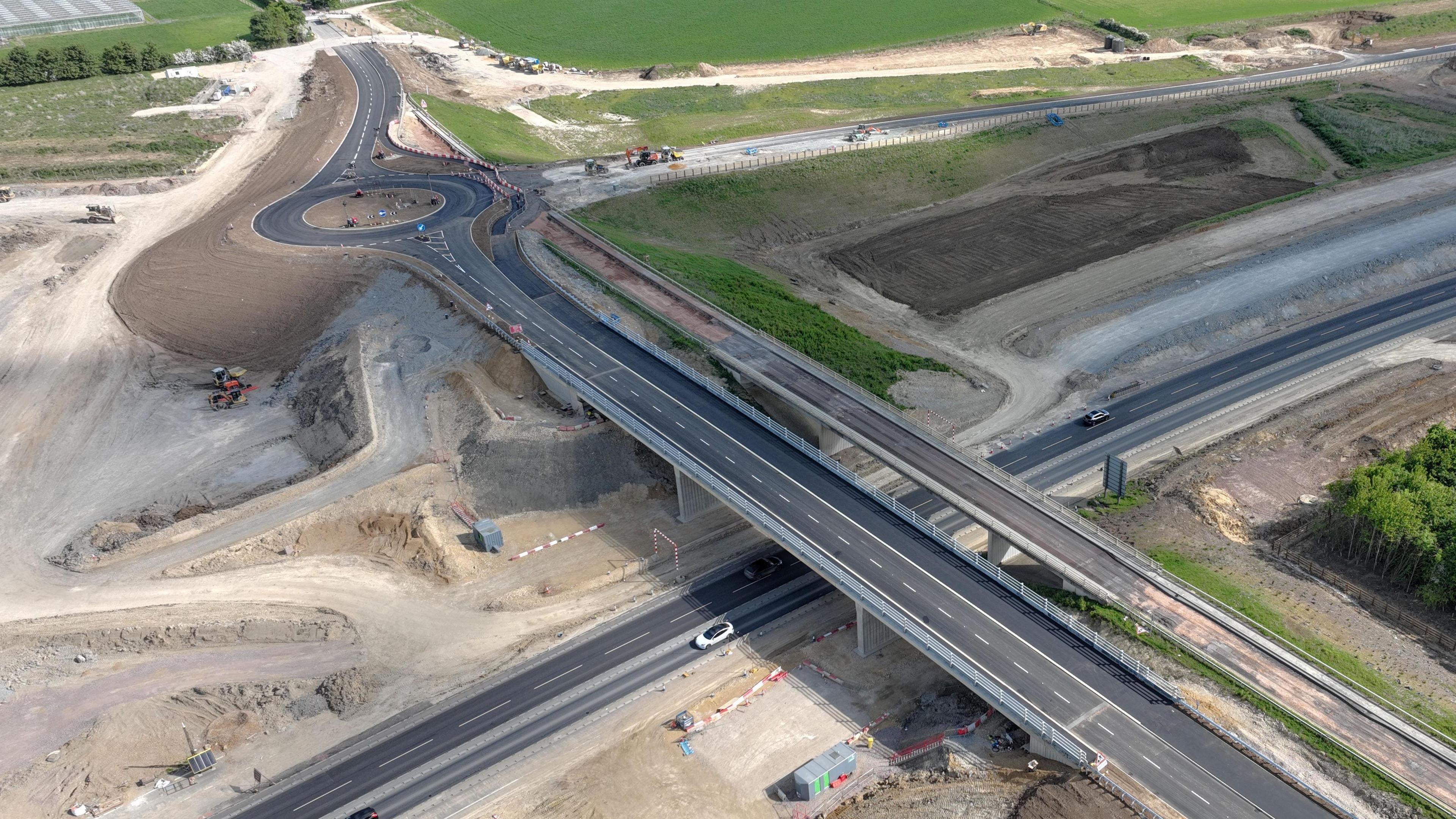 An image of a newly built road in Roxton, Bedfordshire, showing a new bridge, an old bridge, a road underneath, a roundabout and another new road.