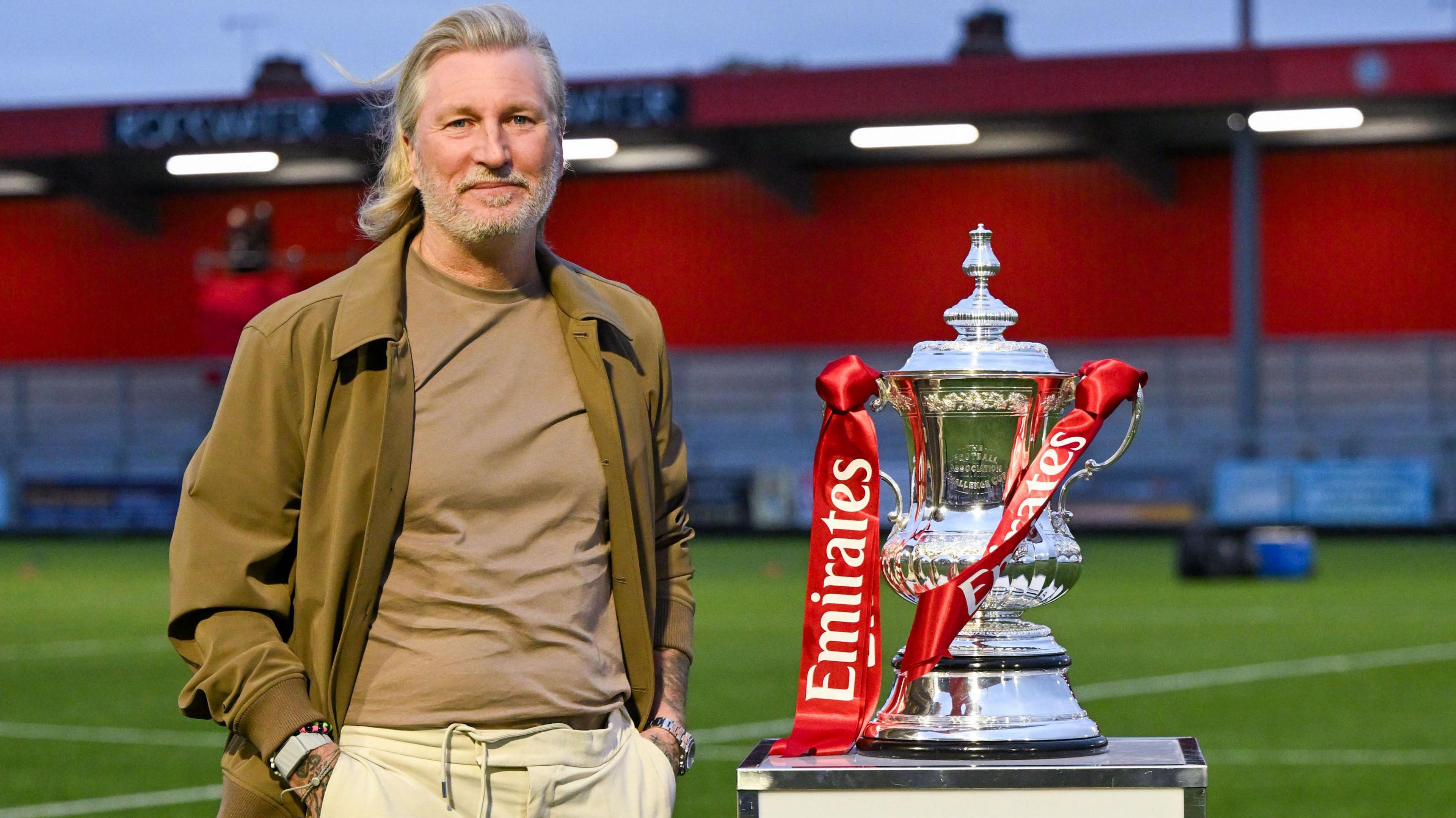 Robbie Savage poses next to the FA Cup