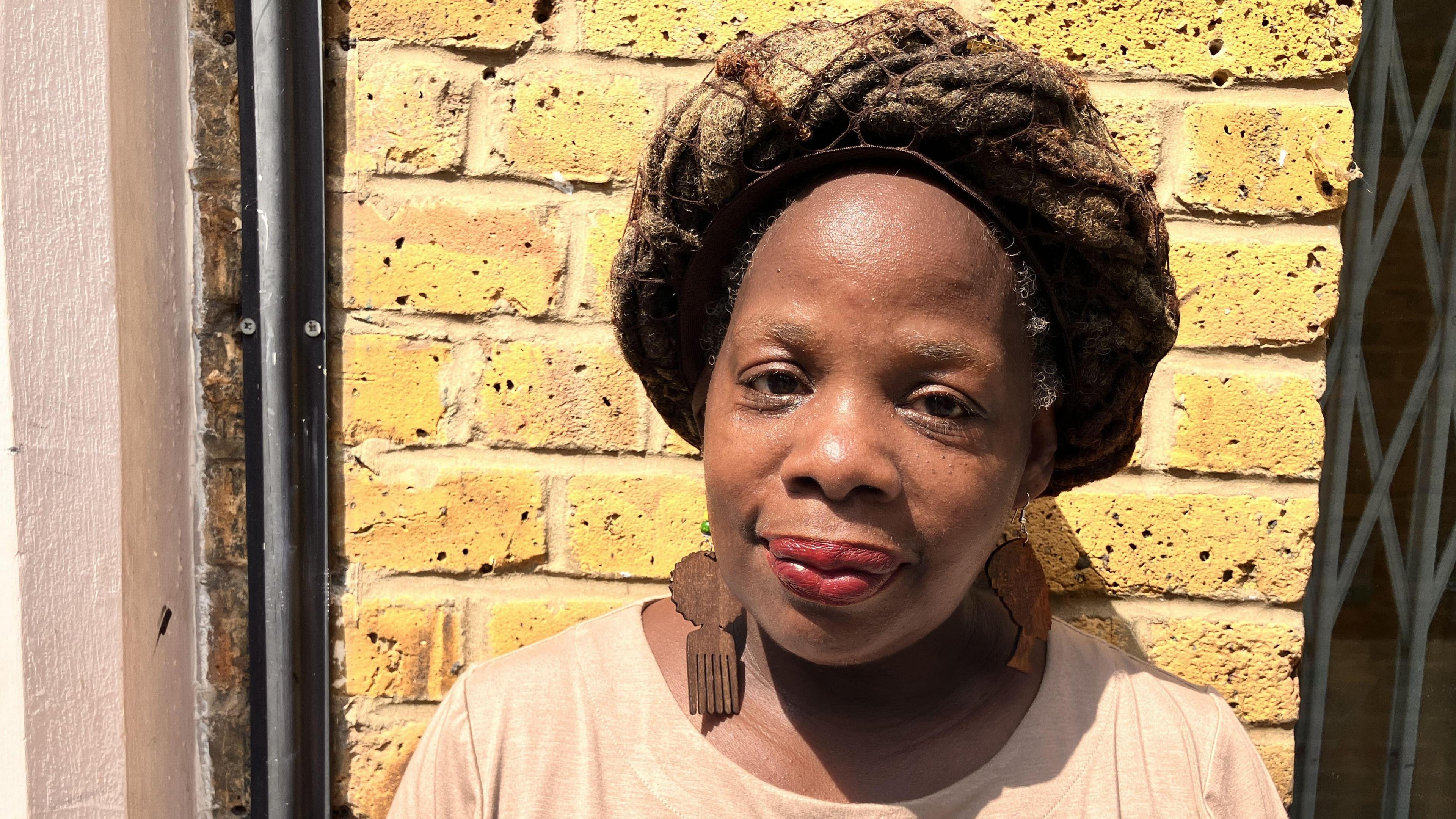 Ngozi Fulani in a creamT-shirt, and looking at the camera.