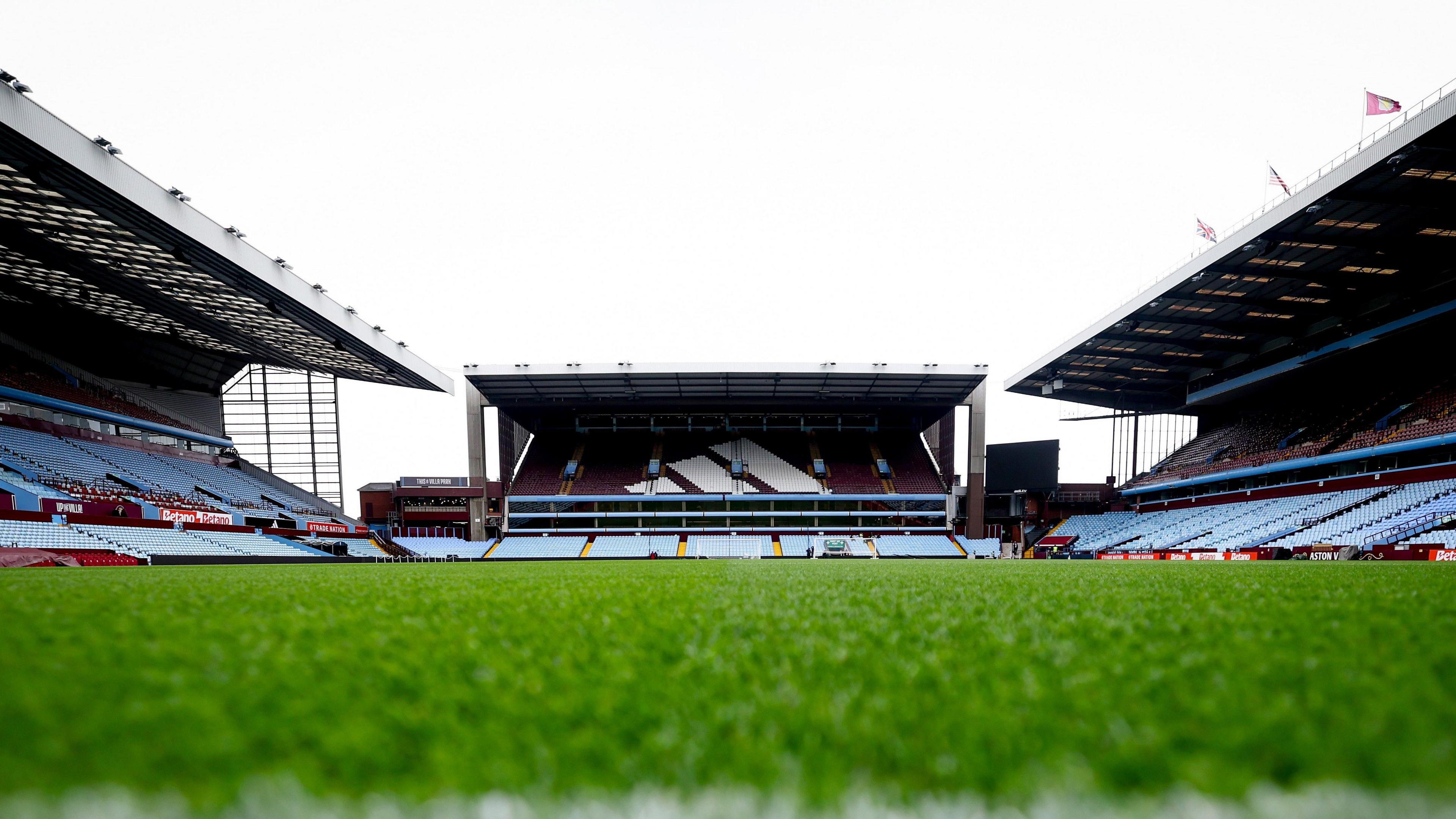 An image of an empty Villa Park taken at the Holte End with an empty North Stand in the background and the pitch low and in the foreground. 