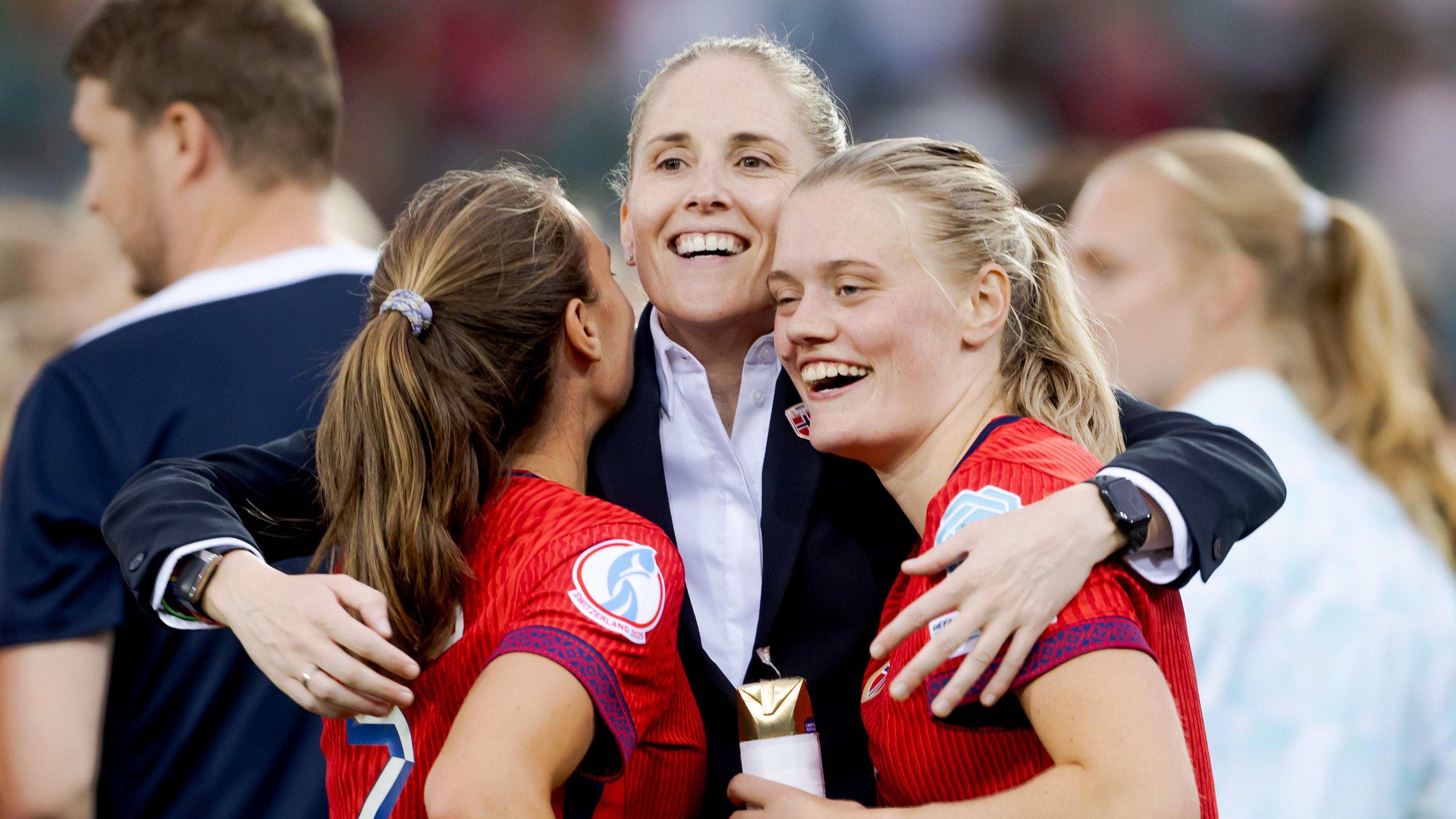 Gemma Grainger embraces Marit Bratberg Lund and Tuva Hansen after victory over Finland