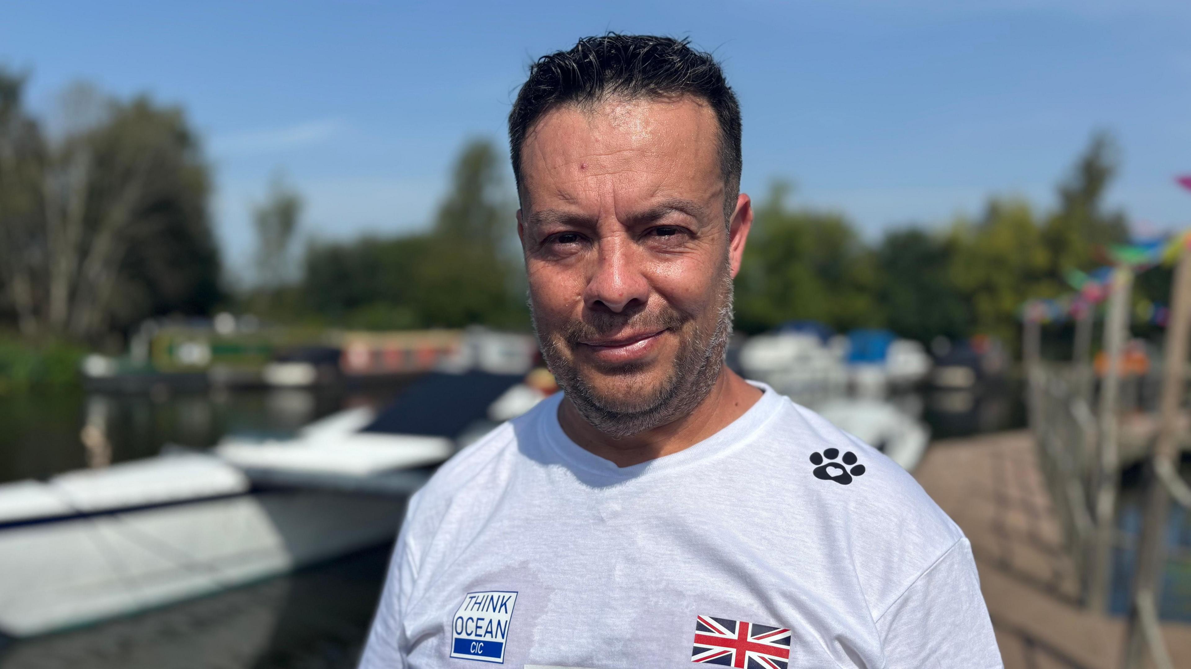 Think Ocean founder Hugo Valdes-Vera standing at a marina