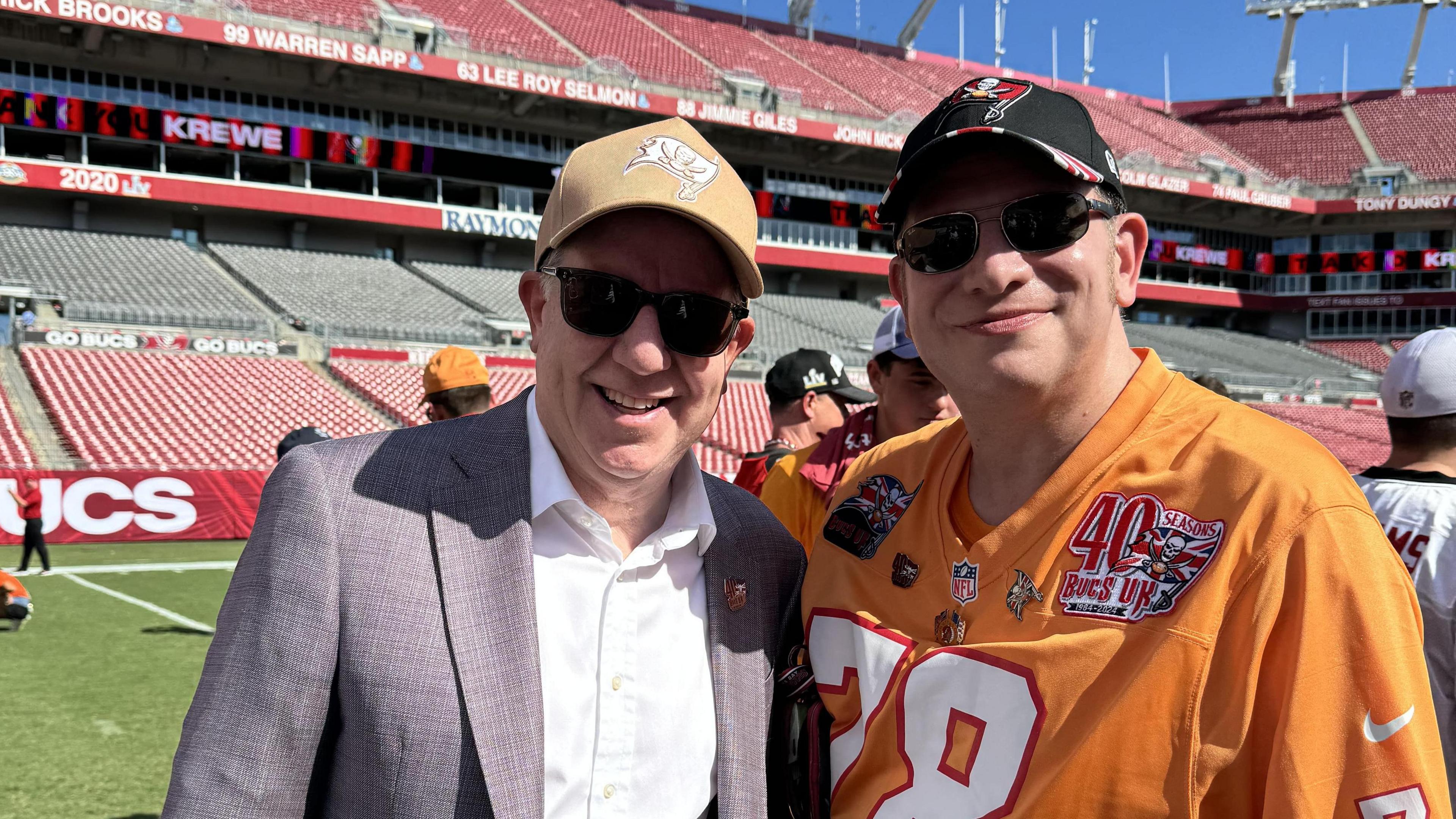 Kieron pictured with one of the Glazers - the family who own the Tampa Bay Buccaneers, on the pitch after the Denver Broncos game in September