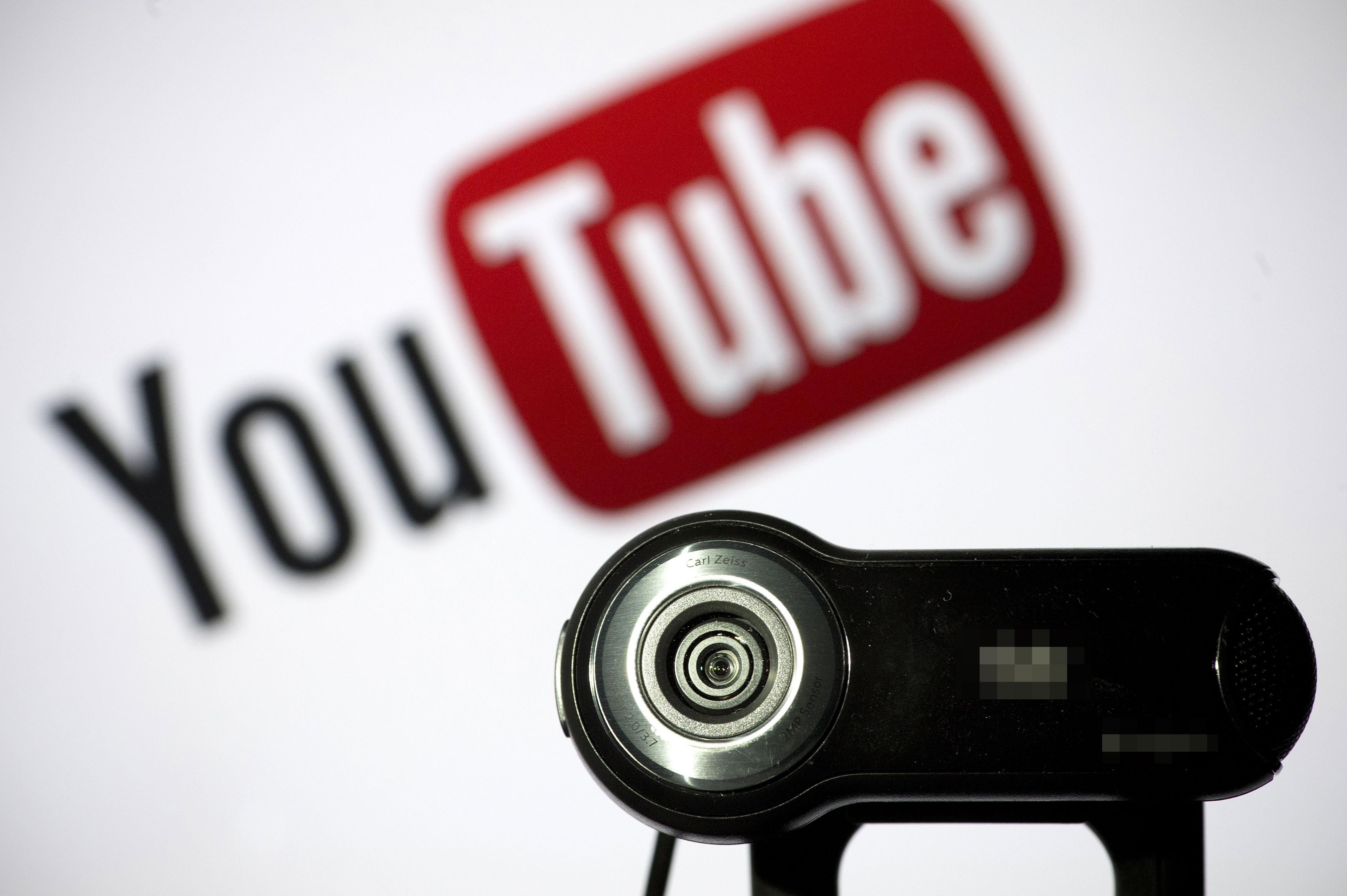 A webcam is positioned in front of a YouTube logo