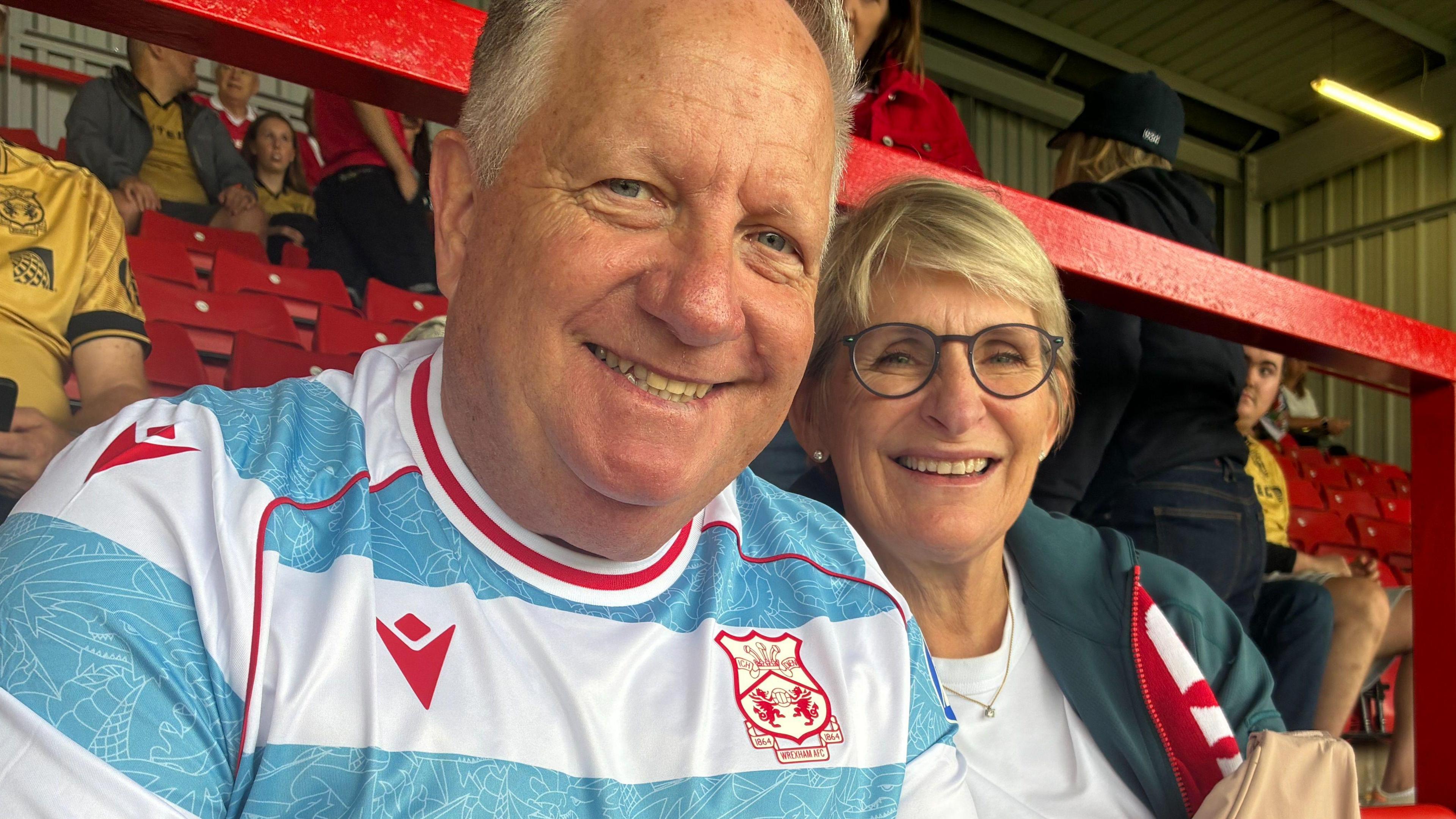 Ian Healy and his wife Helen (right) watch Wrexham in a home game