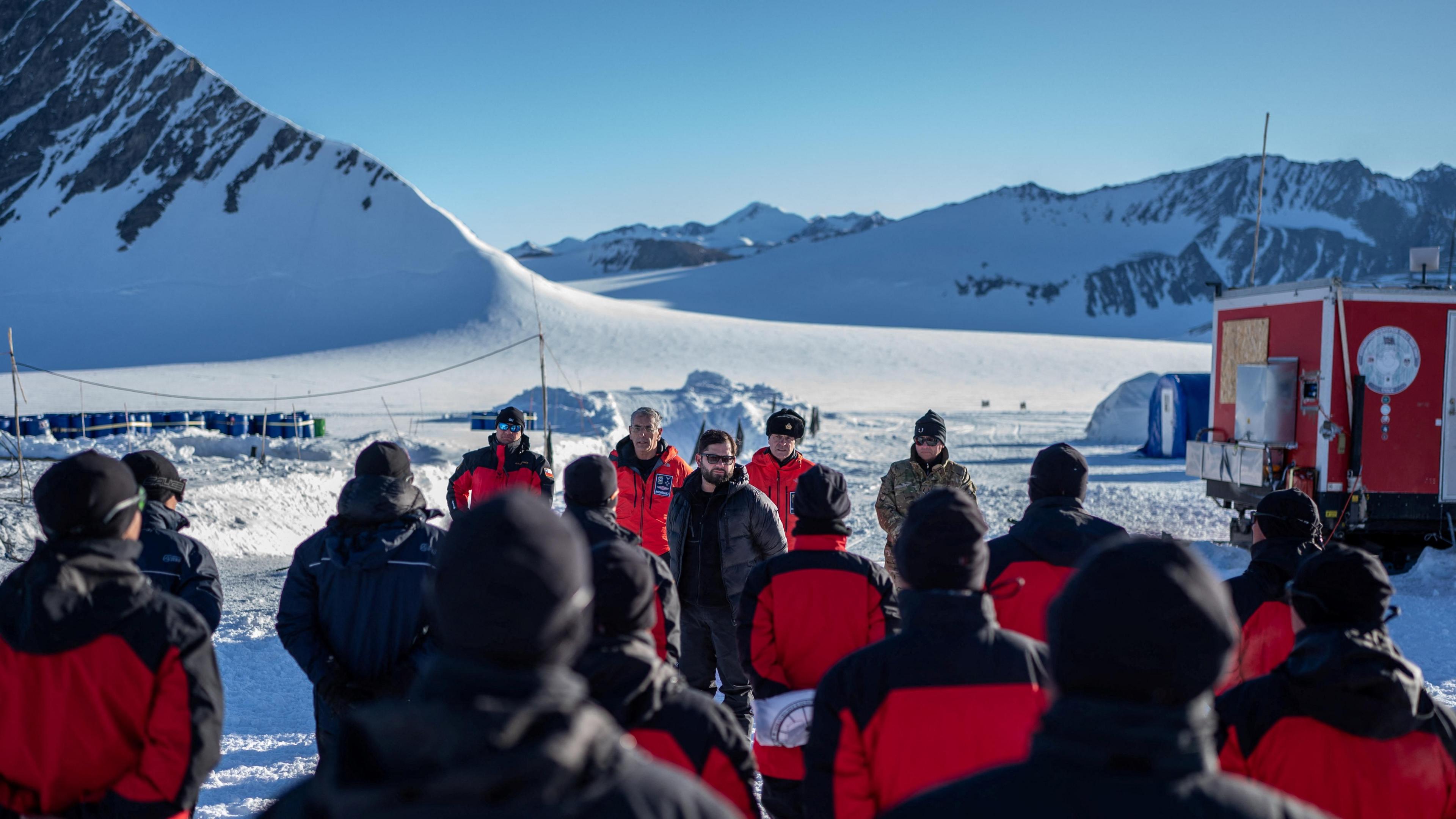 Chile's President Gabriel Boric talks with base staff members during his historic visit to the South Pole in Antarctica, 3 January