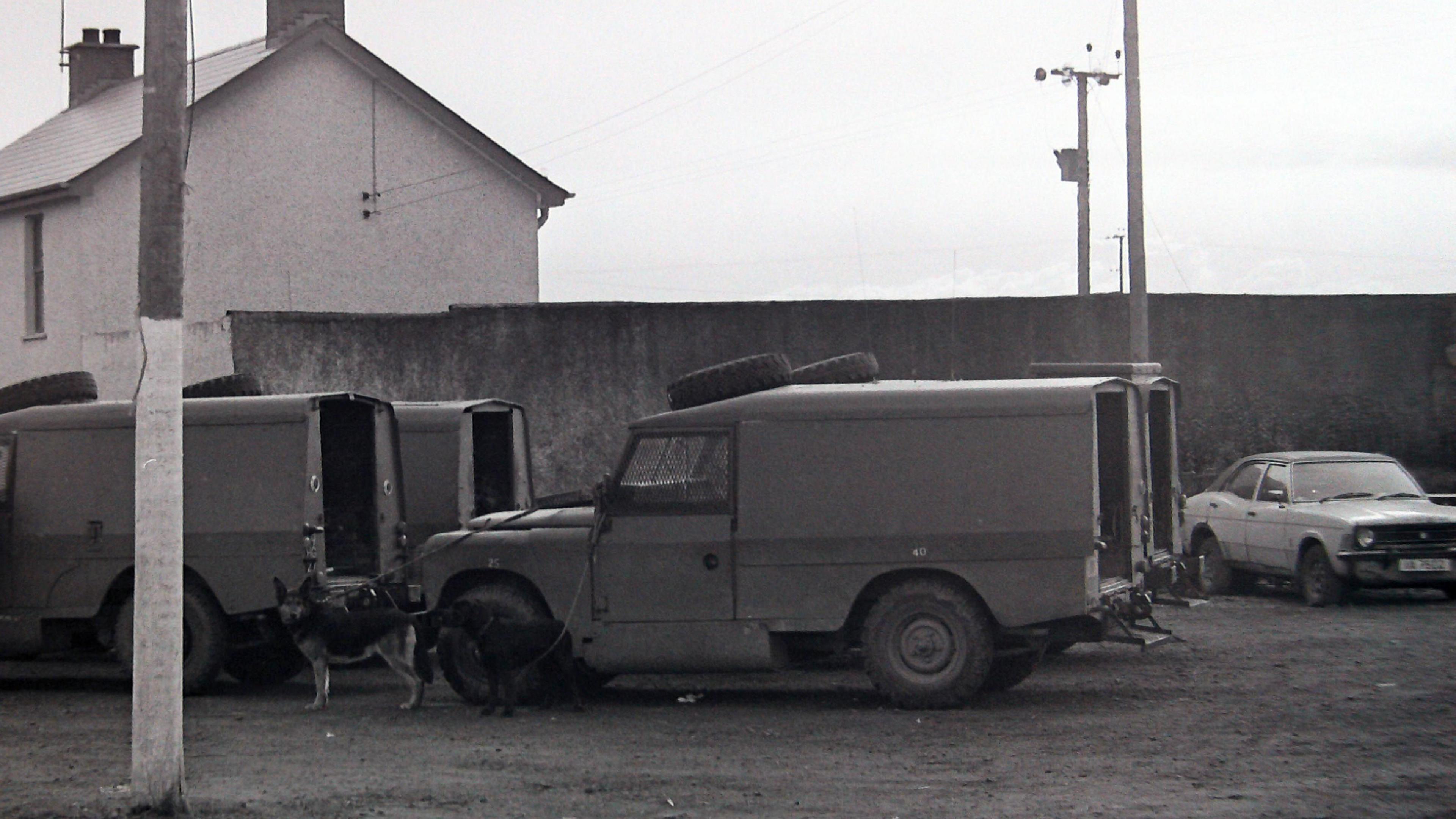 Archive shot of the scene showing police vehicles outside a house