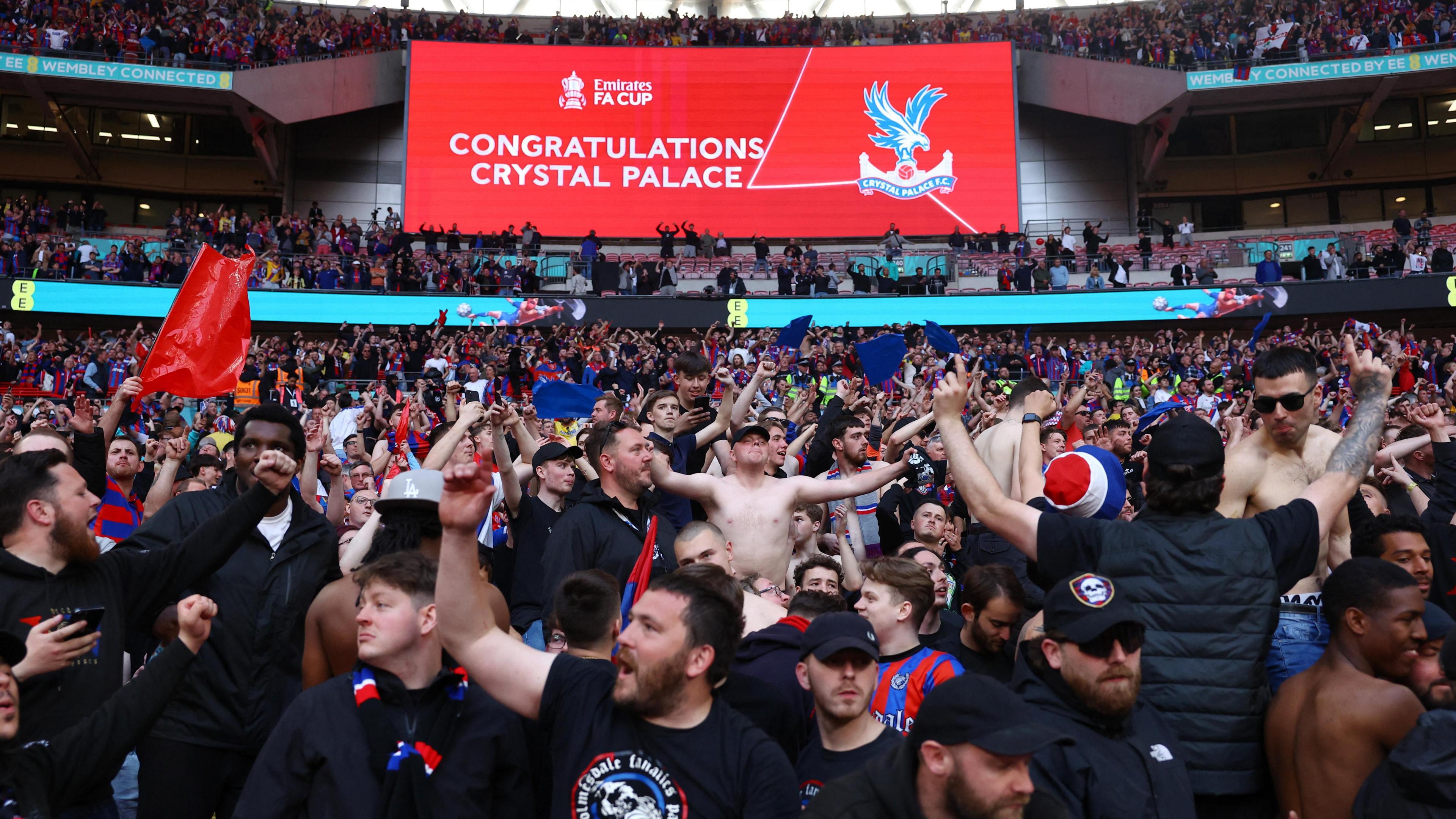 Fans cheer in the stands at Wembley Stadium