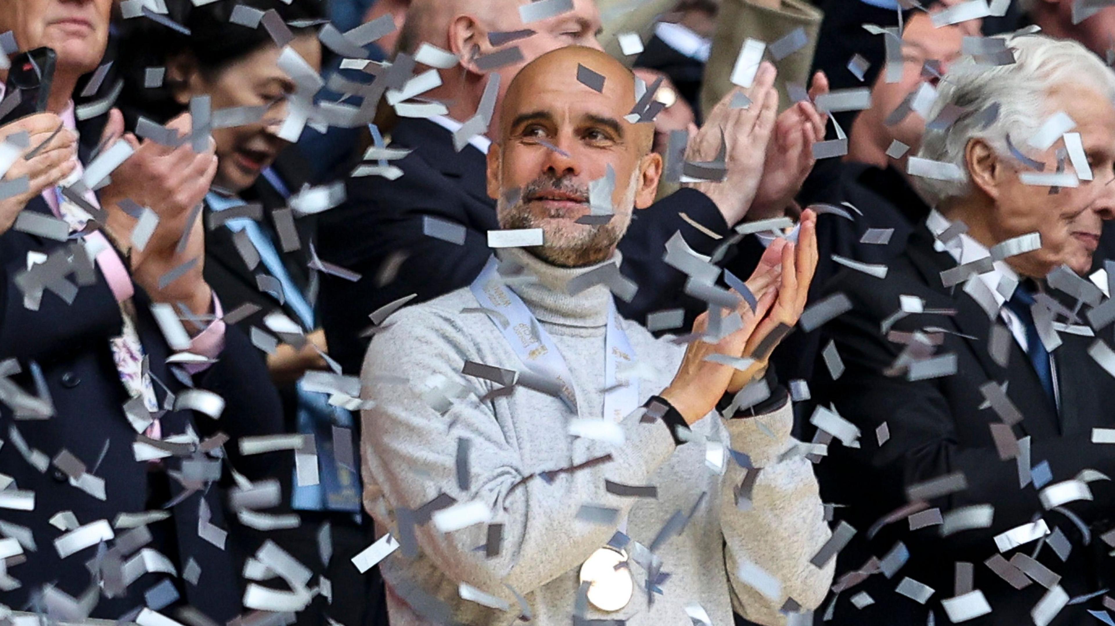 Pep Guardiola waits for the FA Cup trophy lift