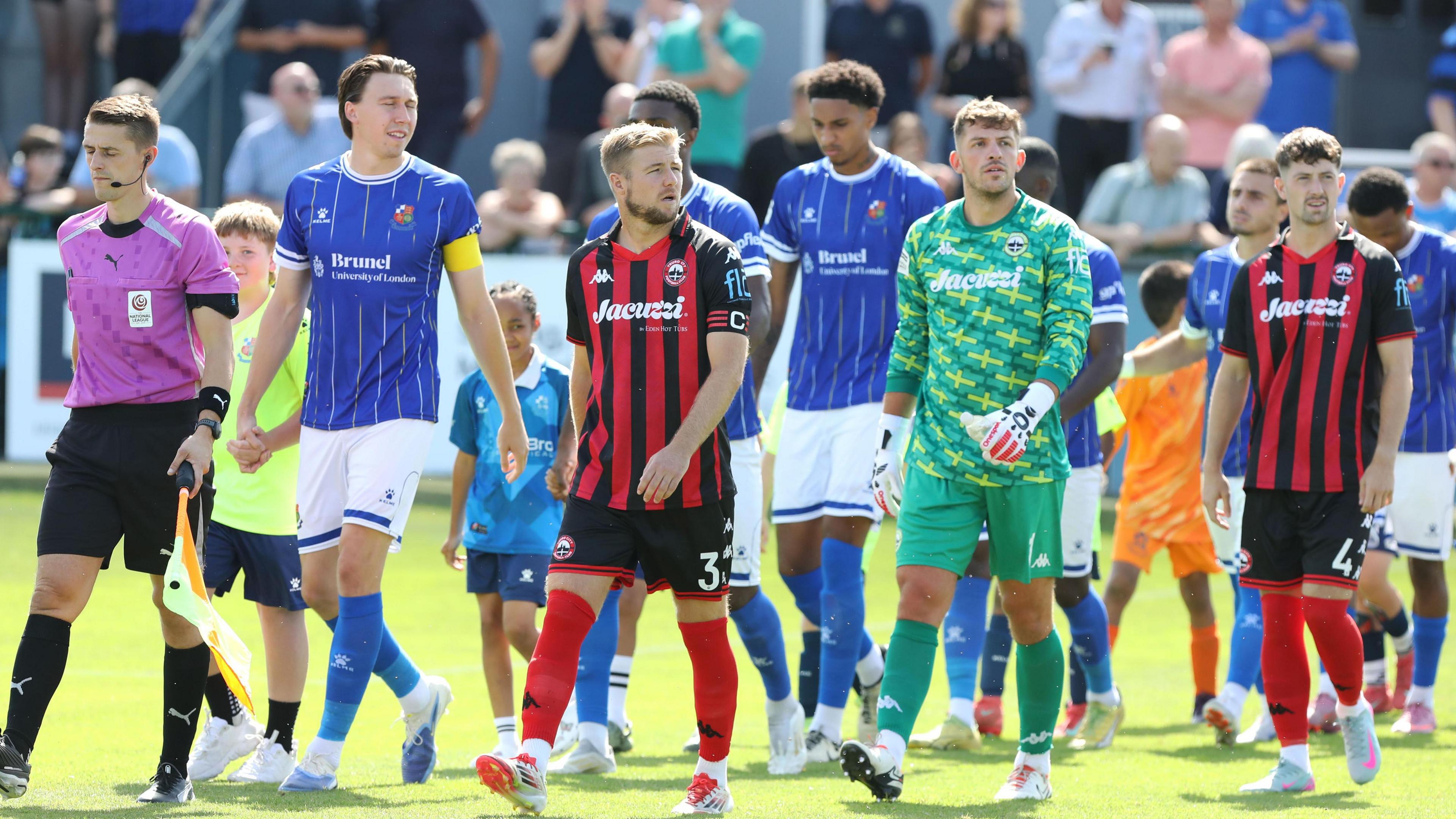 Truro City and Wealdstone players walk out for kick off