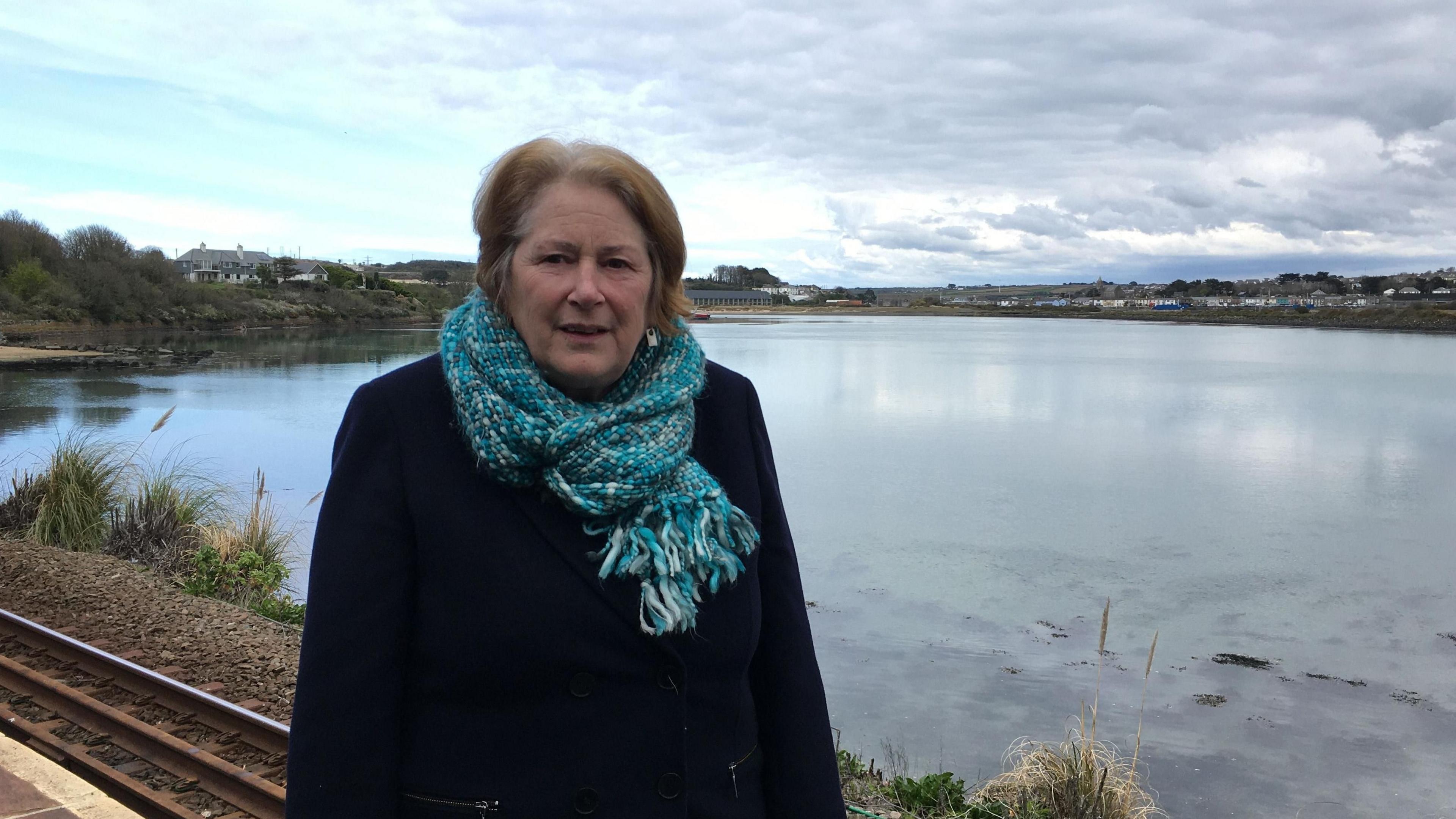 Woman standing in front of lake