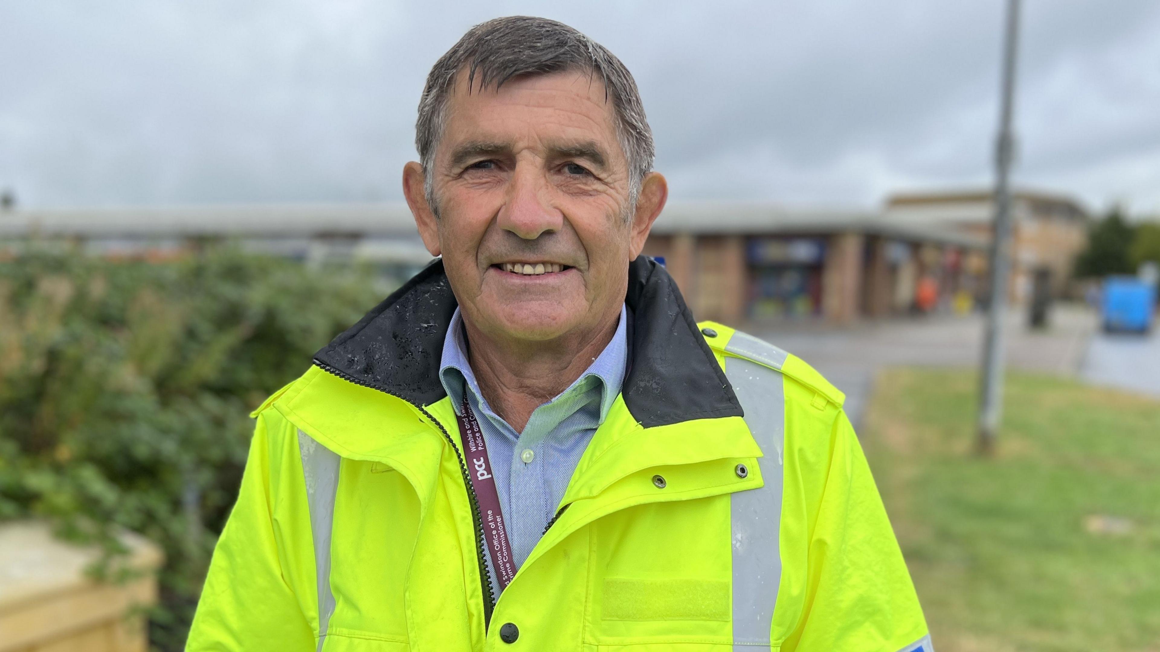 The Police and Crime Commissioner, Philip Wilkinson, smiling and wearing a high-visibility police jacket