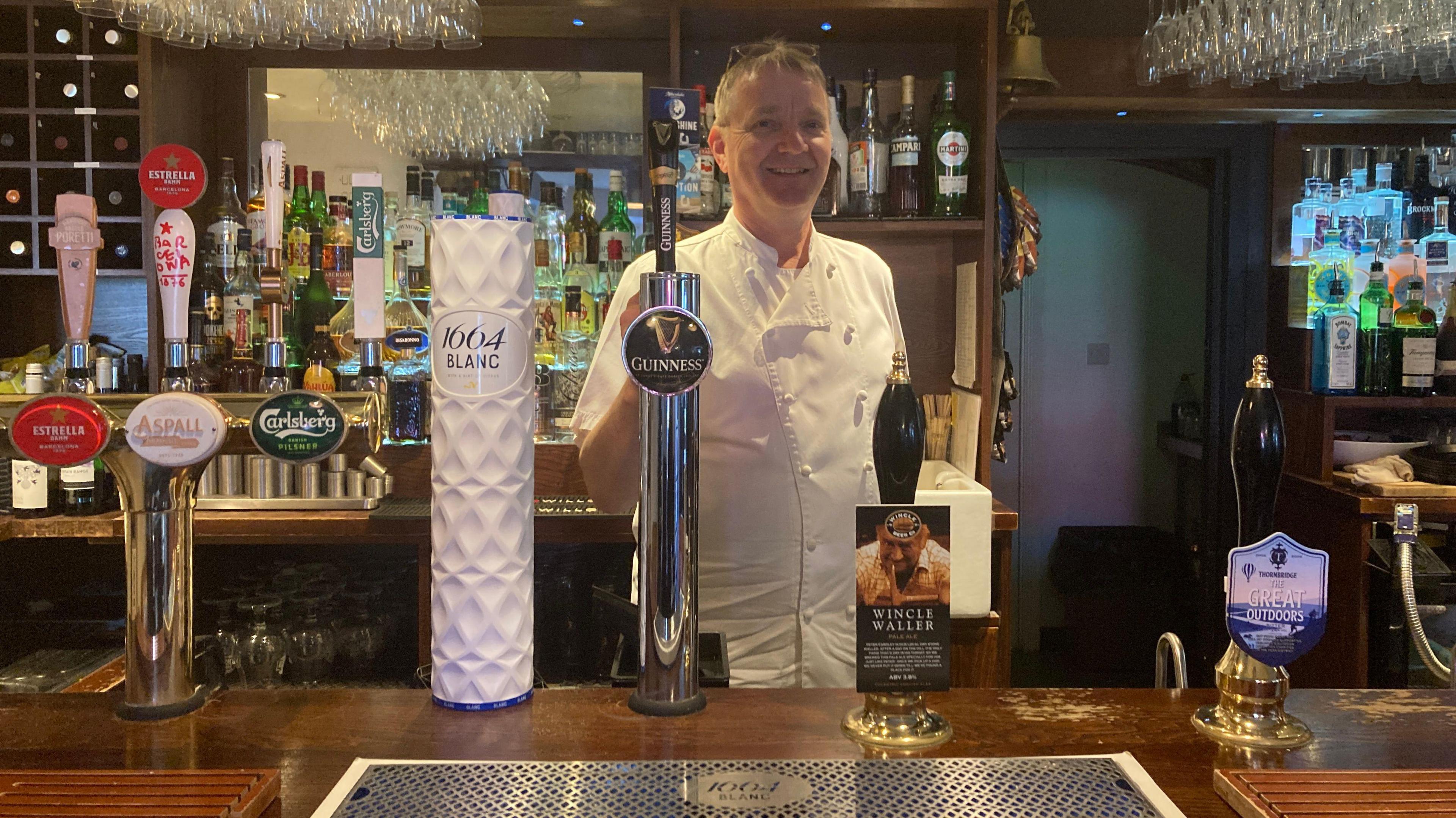 Robert Cloughley, licensee of the Swan Inn in Kettleshulme, Cheshire. He is stood behind his bar.