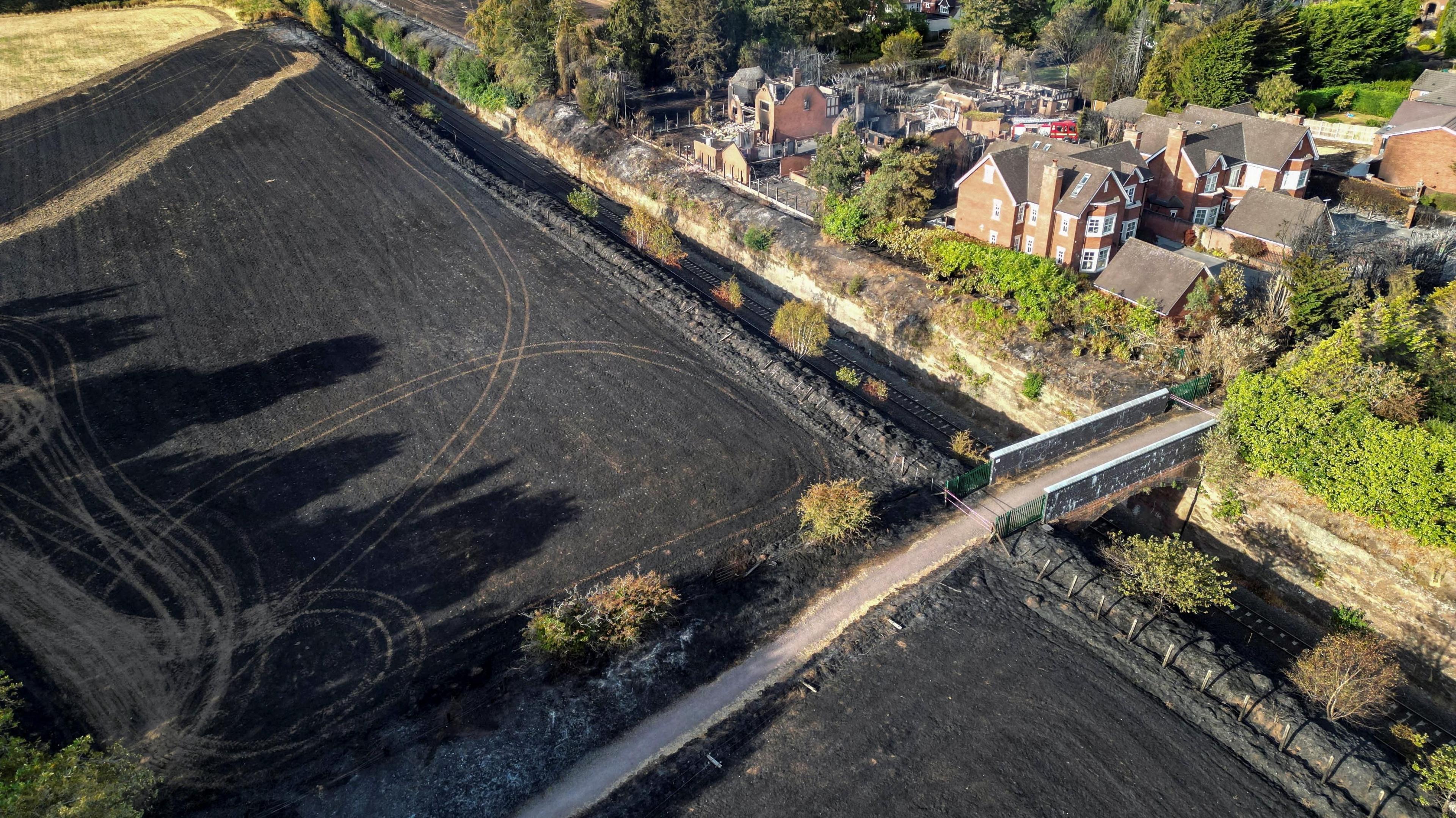 A drone view showing where the fire spread in Stourbridge, with blakcened fields and burnt homes and gardens. 
