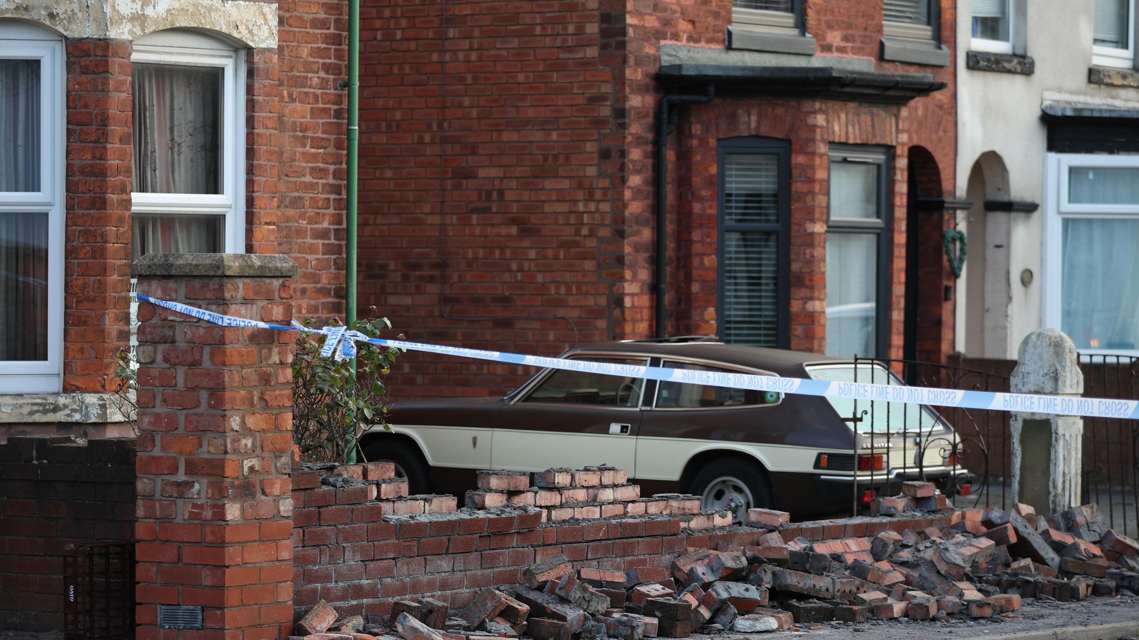 Damaged wall rubble at a Southport mosque taped off by police after disorder following online disinformation about the murder of three girls in the town.