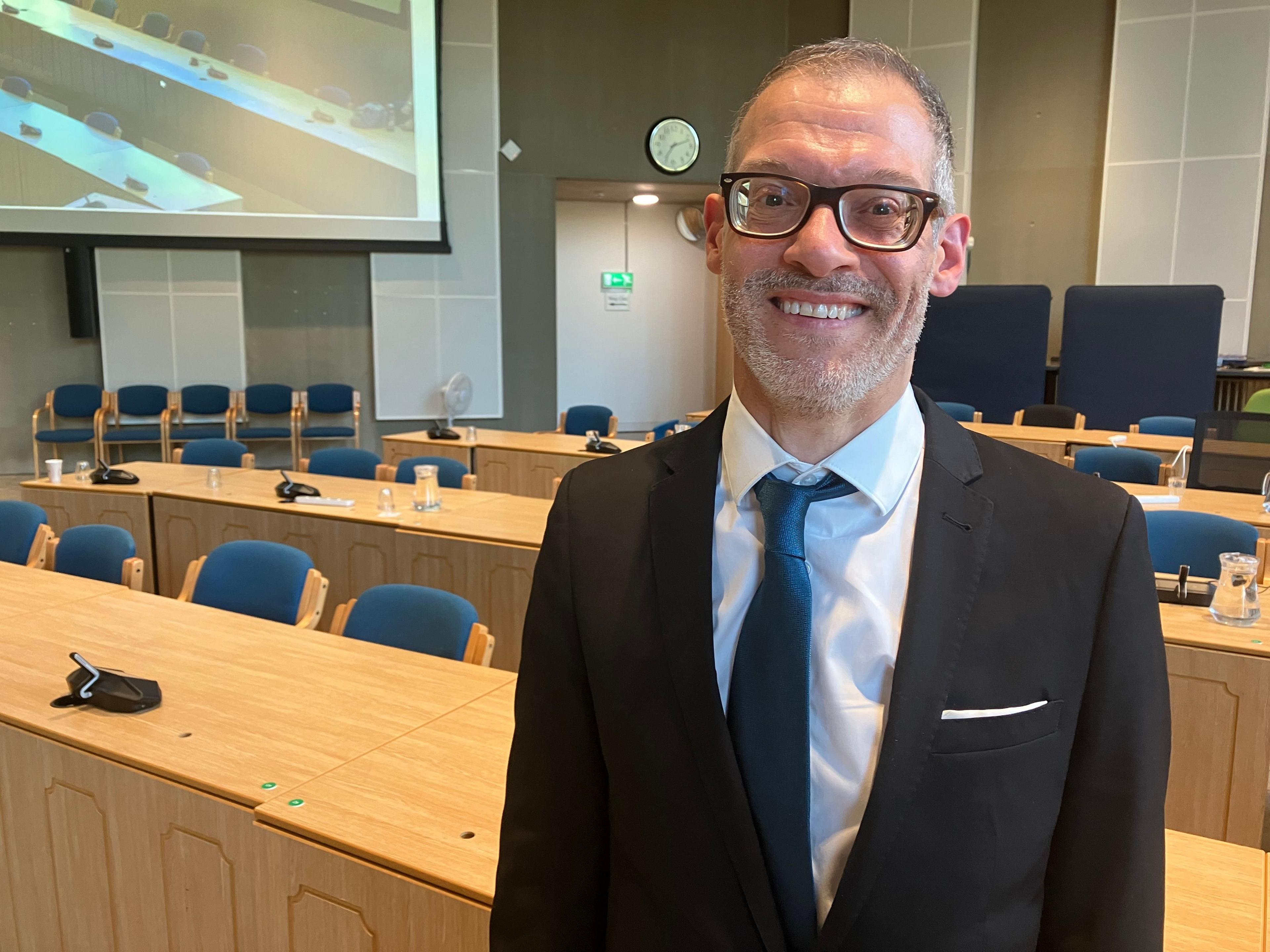 A picture of Independent Leader of Central Beds Council Adam Zerny in a black suit with a turqouise coloured tie.