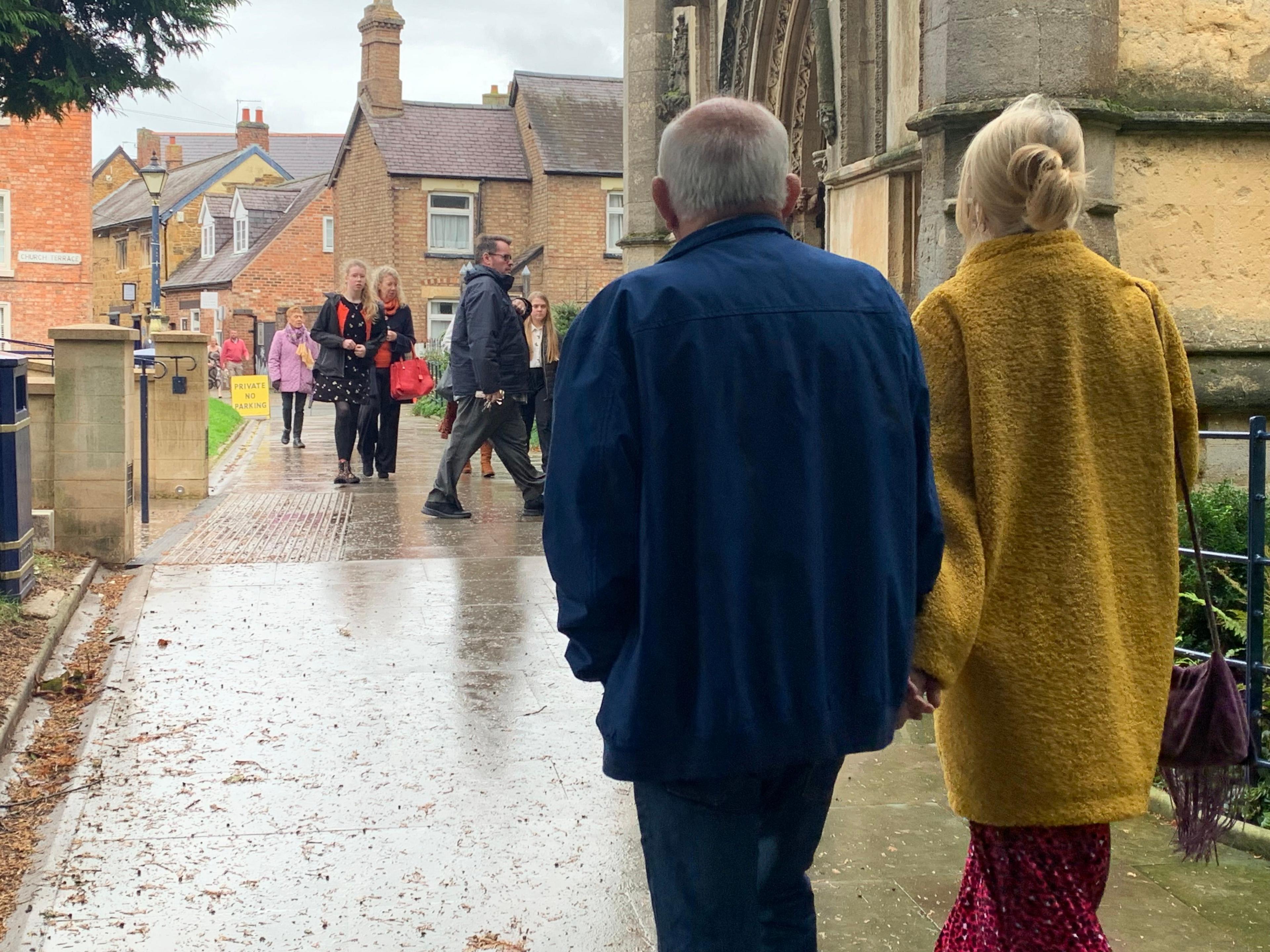 People, smartly dressed, arrive at St Mary's Church