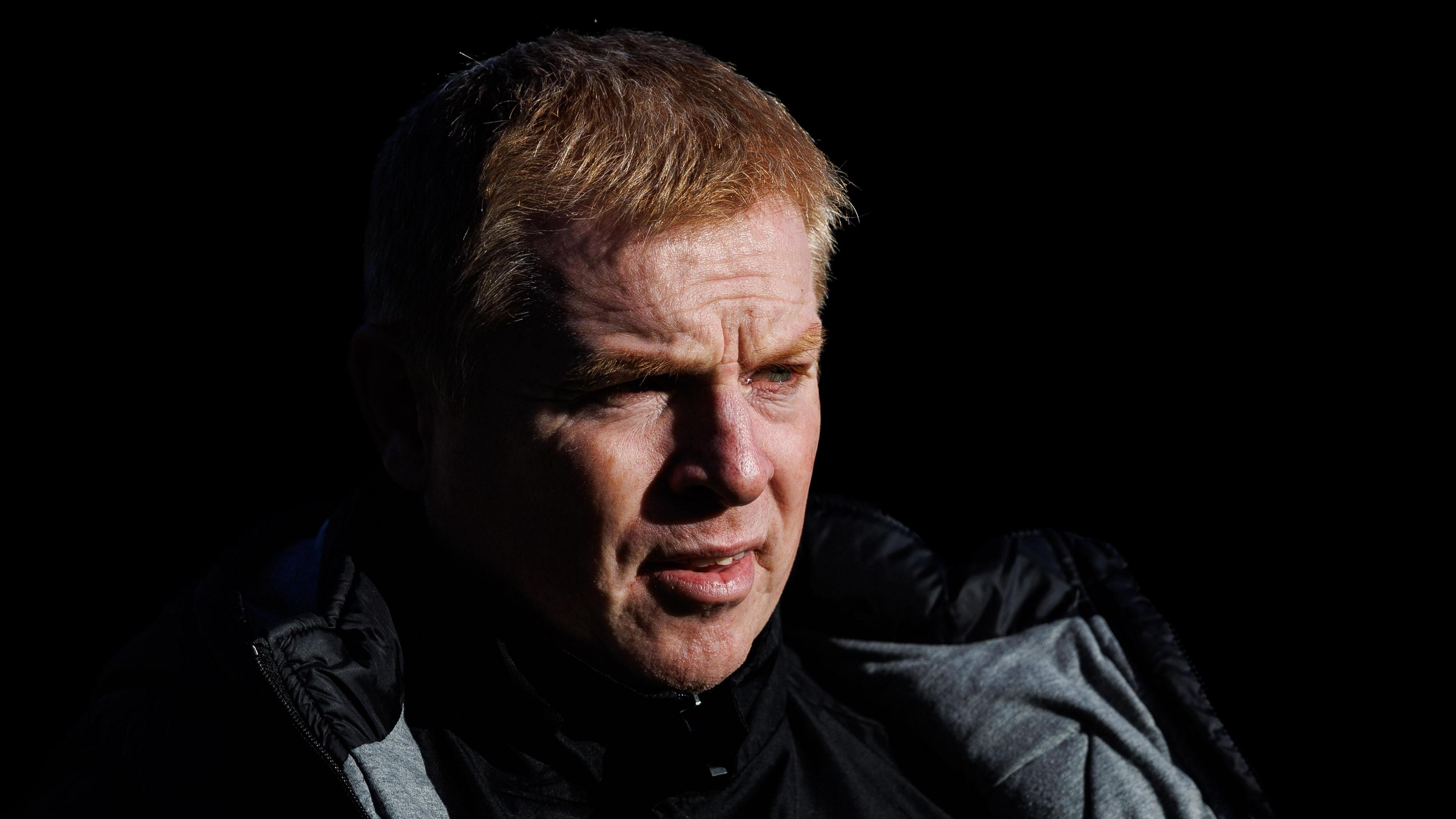Dunfermline Athletic manager Neil Lennon is pictured in shadow against a black background