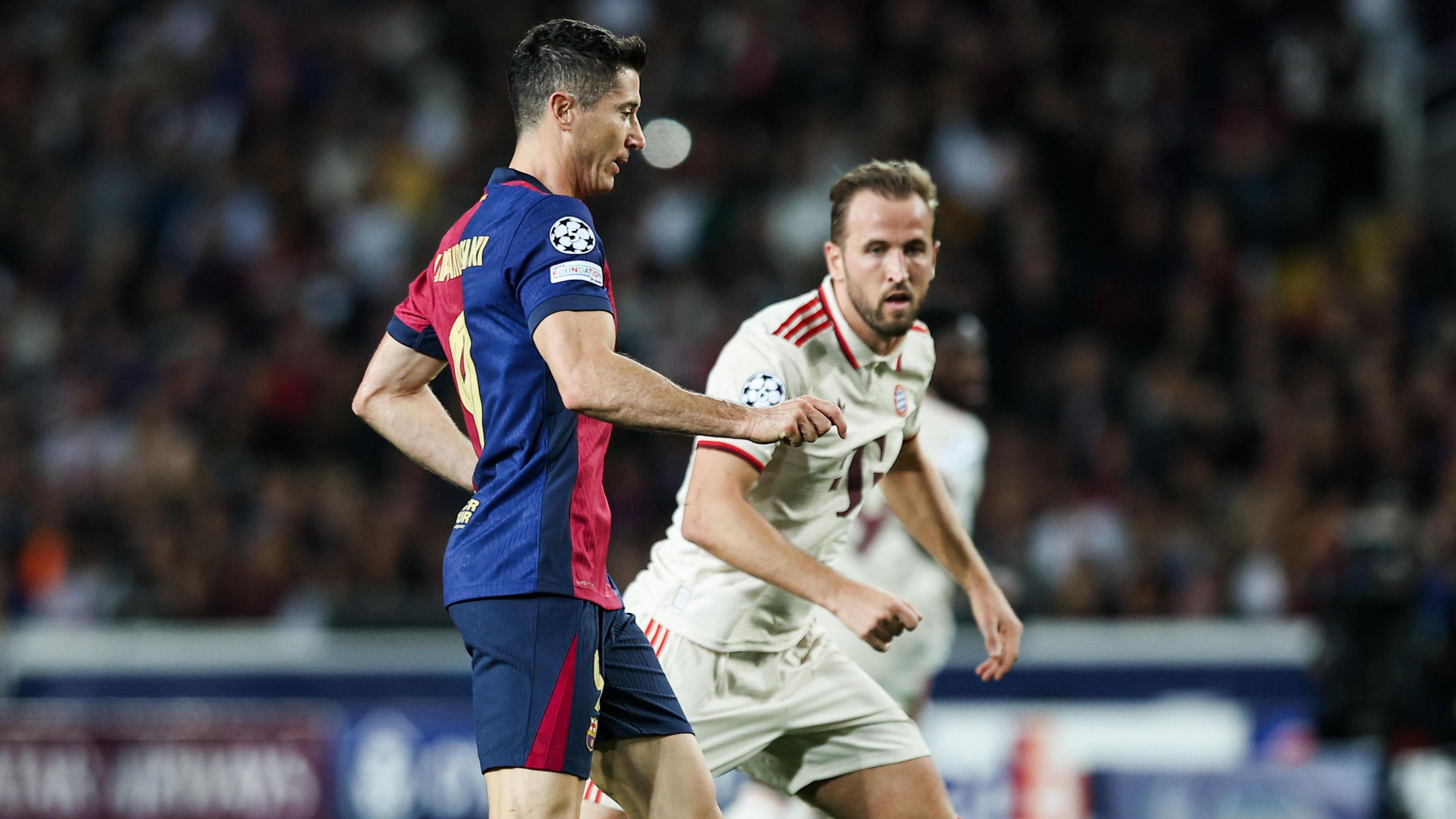 Robert Lewandowski and Harry Kane playing against each other in a match between Barcelona and Bayern Munich