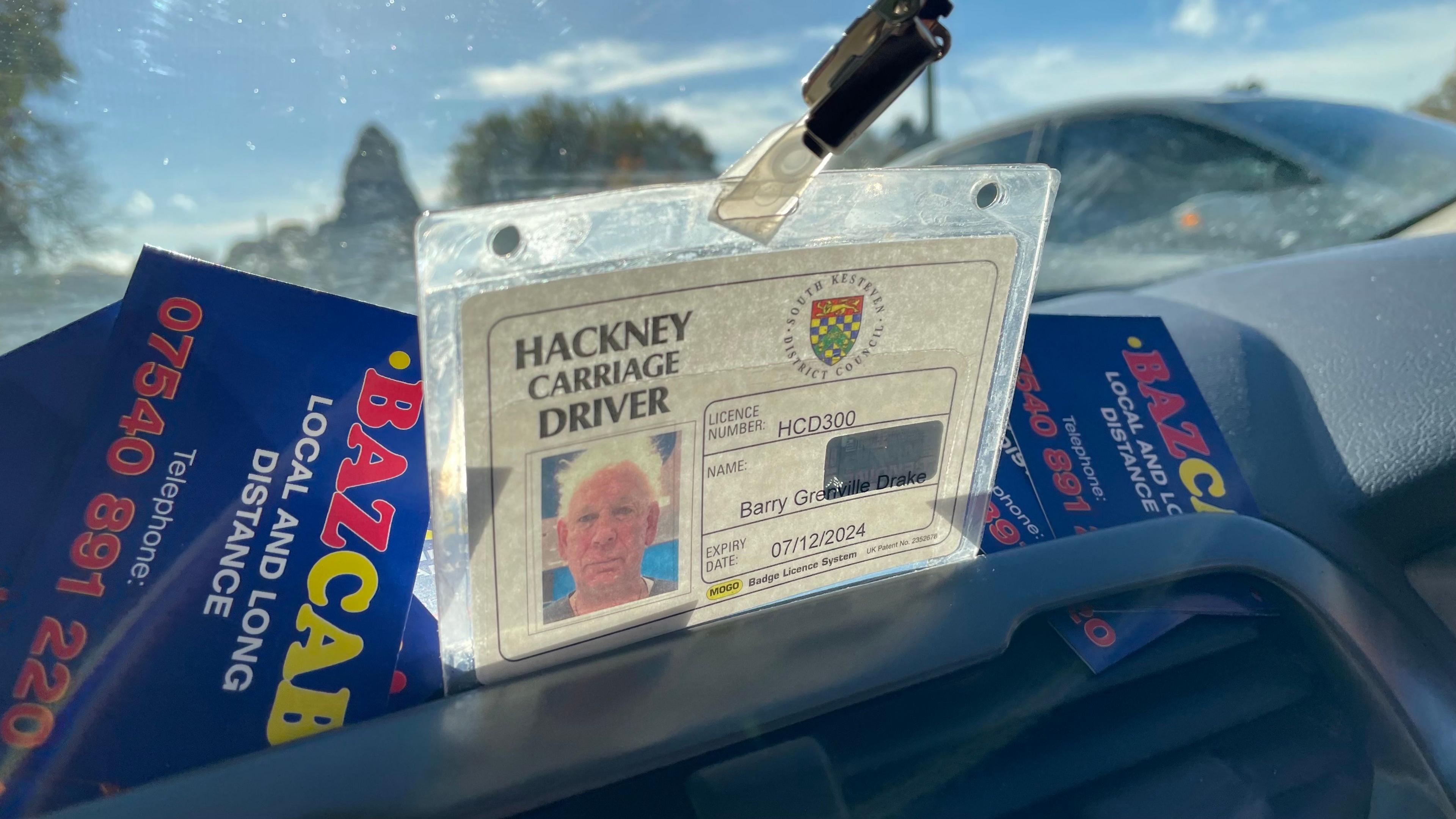 Barry Drake's badge which shows his licence to operate as a taxi driver.