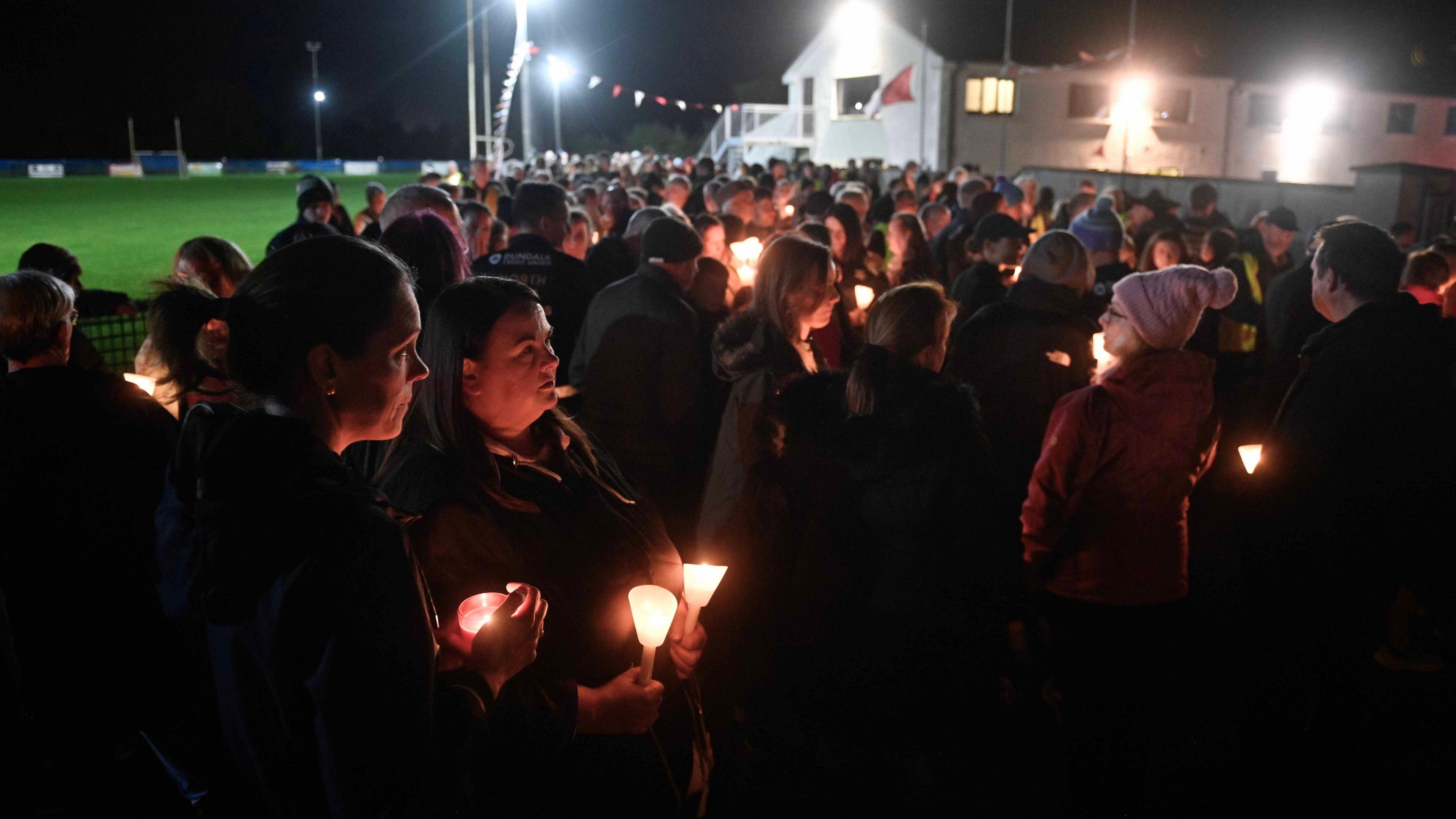 Crowds holding candles at Stonetown Community Walking Track in Louth for Mark and Louise O'Connor and their son Evan.