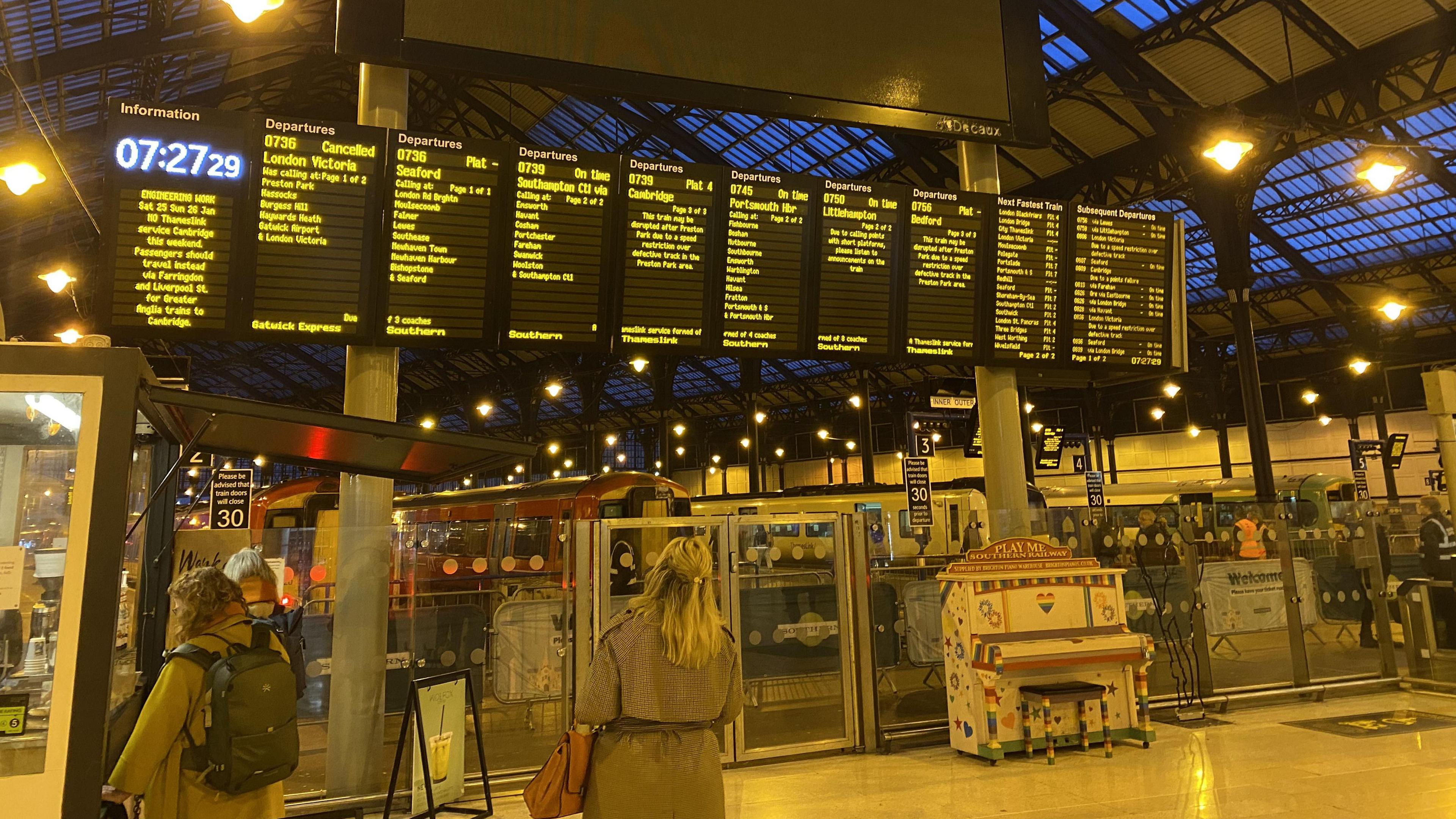 A large train departure board in Brighton railway station