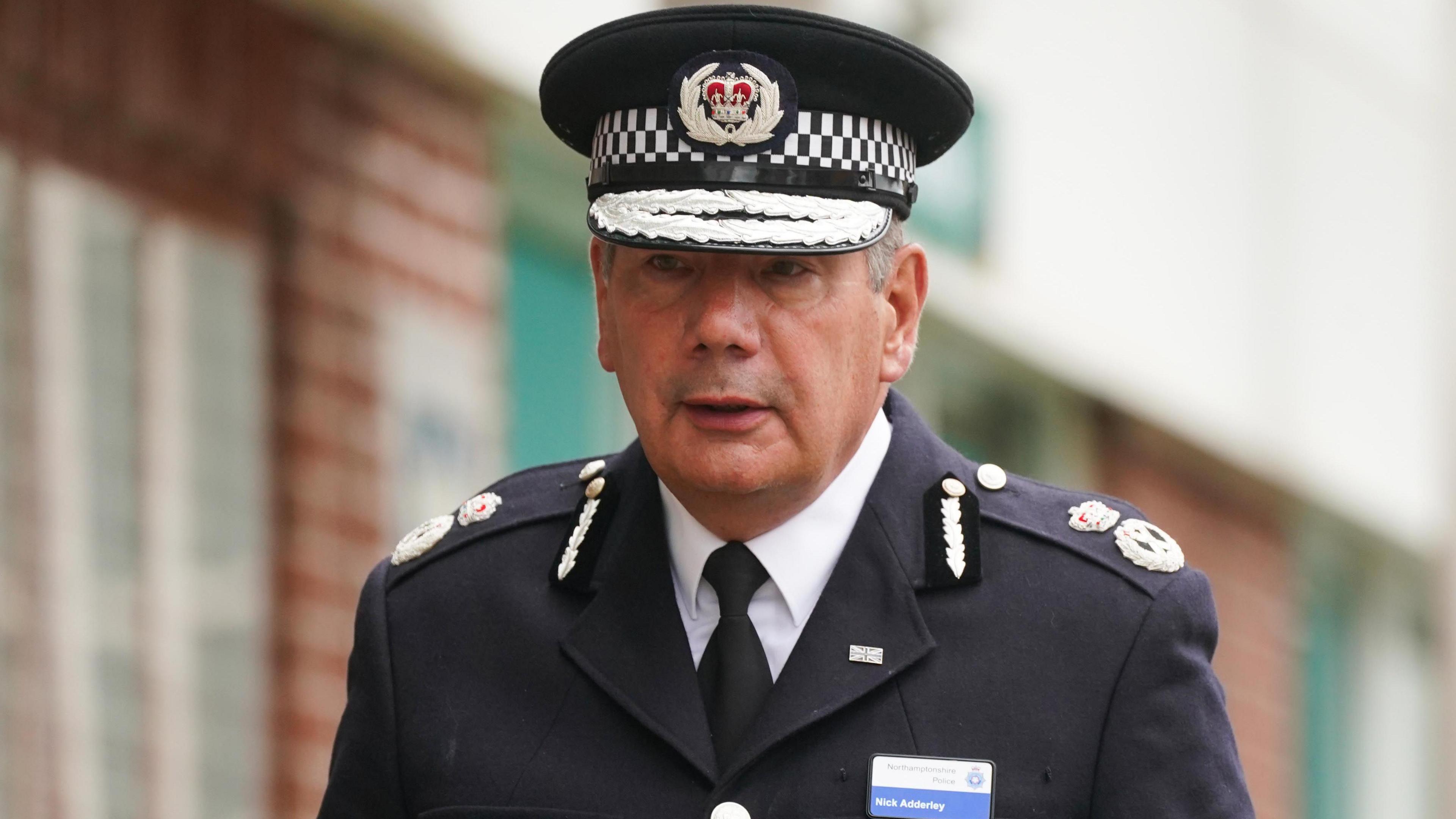 Police officer in uniform leaving a venue