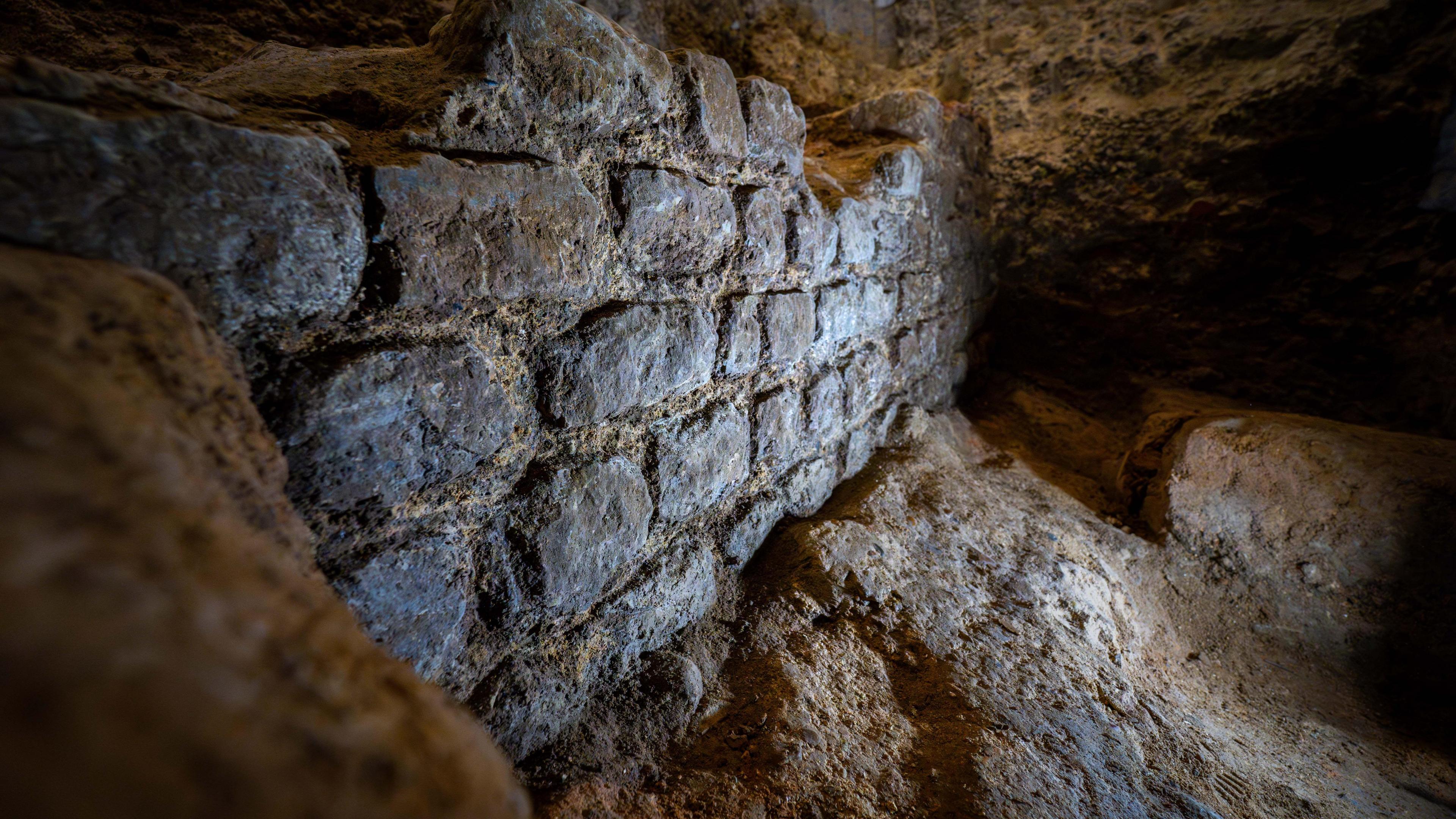 A close up picture of a the side of a well preserved piece of the 2,000 year old Roman wall made of limestone.  The individual stones can be seen as well as the mortar in between them.  