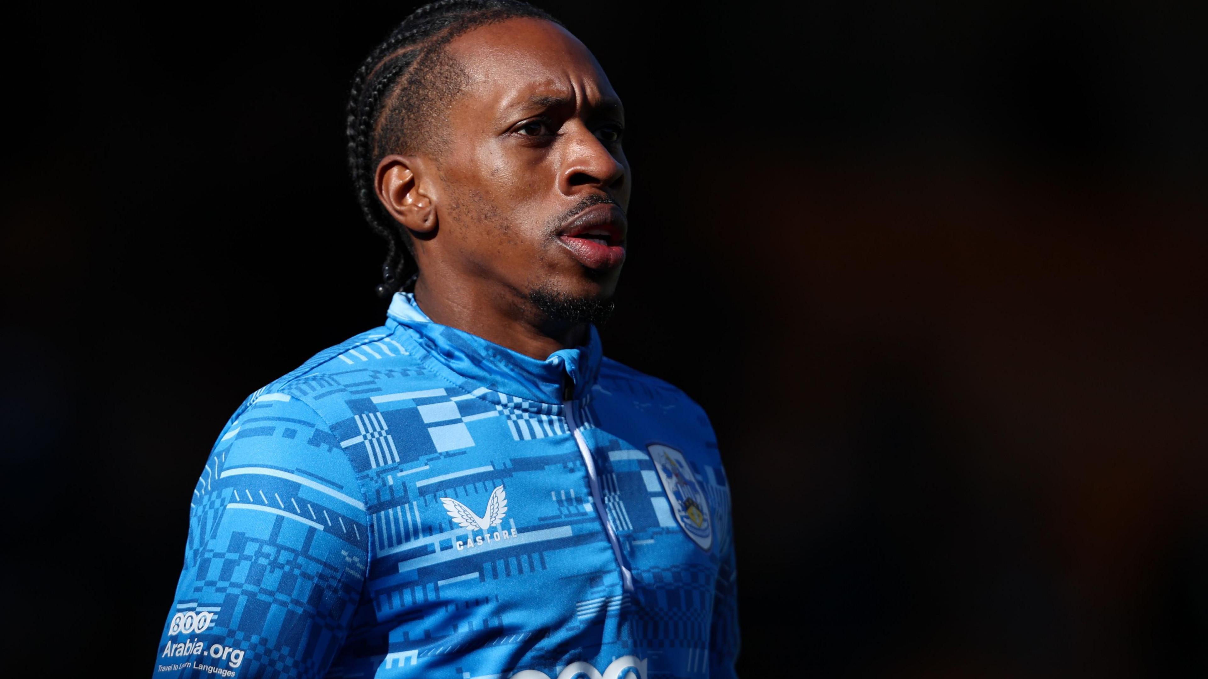 Mickel Miller warming up before a Huddersfield Town match