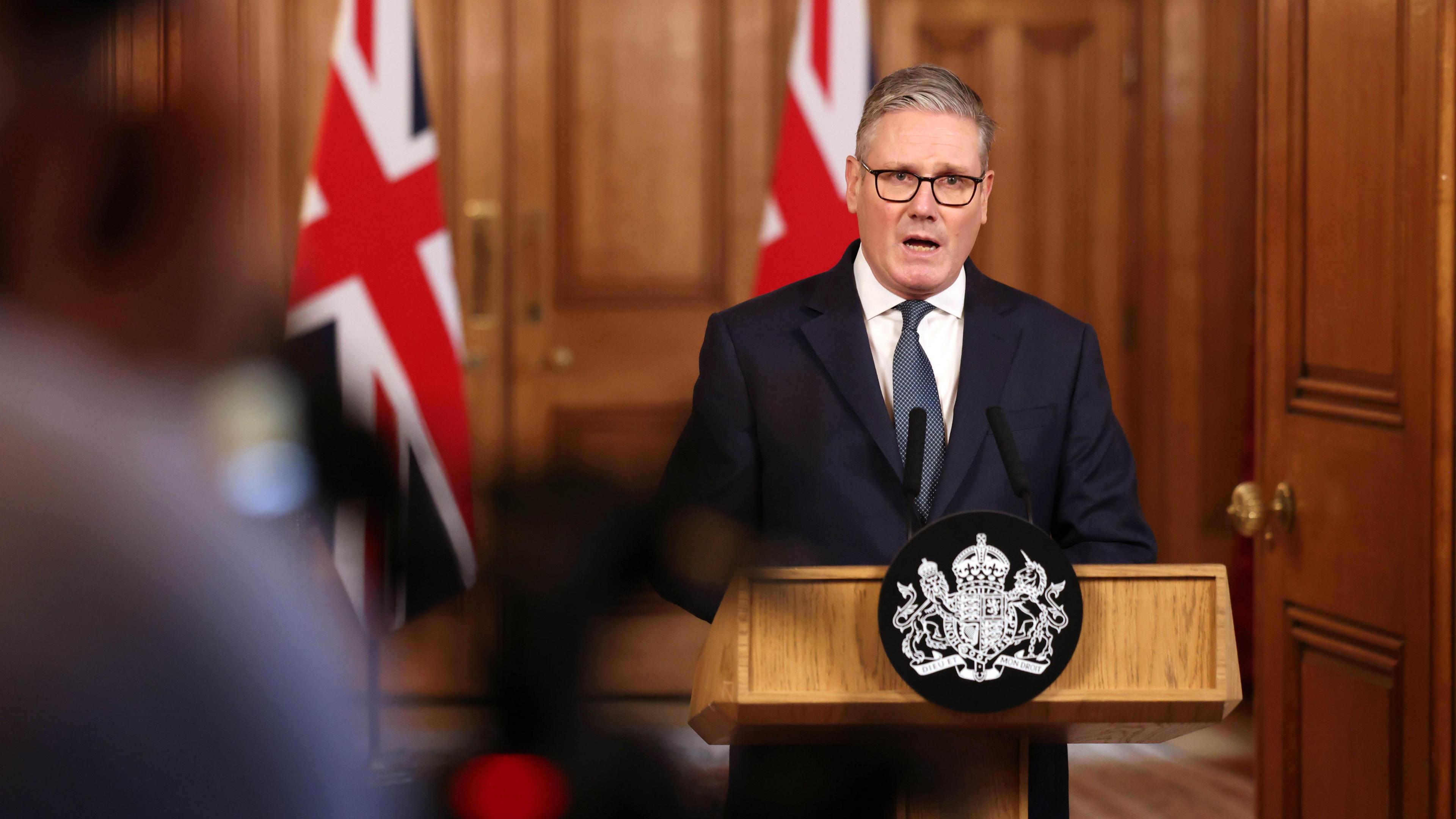 Prime Minister Keir Starmer speaking in front of union flags