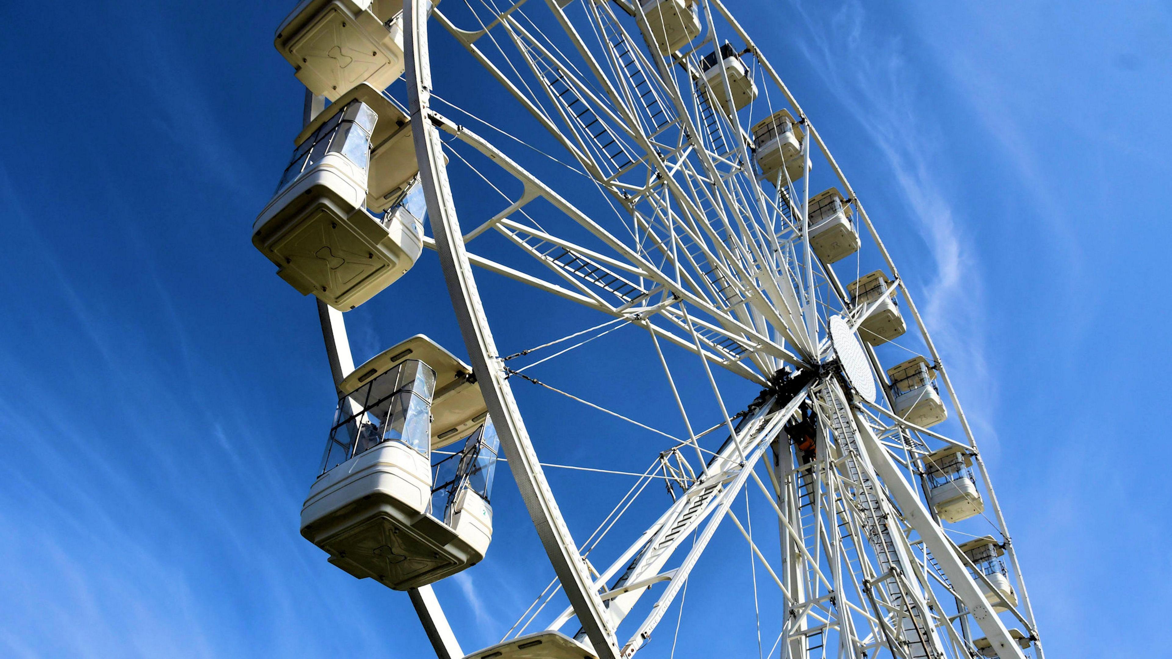 A ferris wheel shot from below against a deep blue sky. 