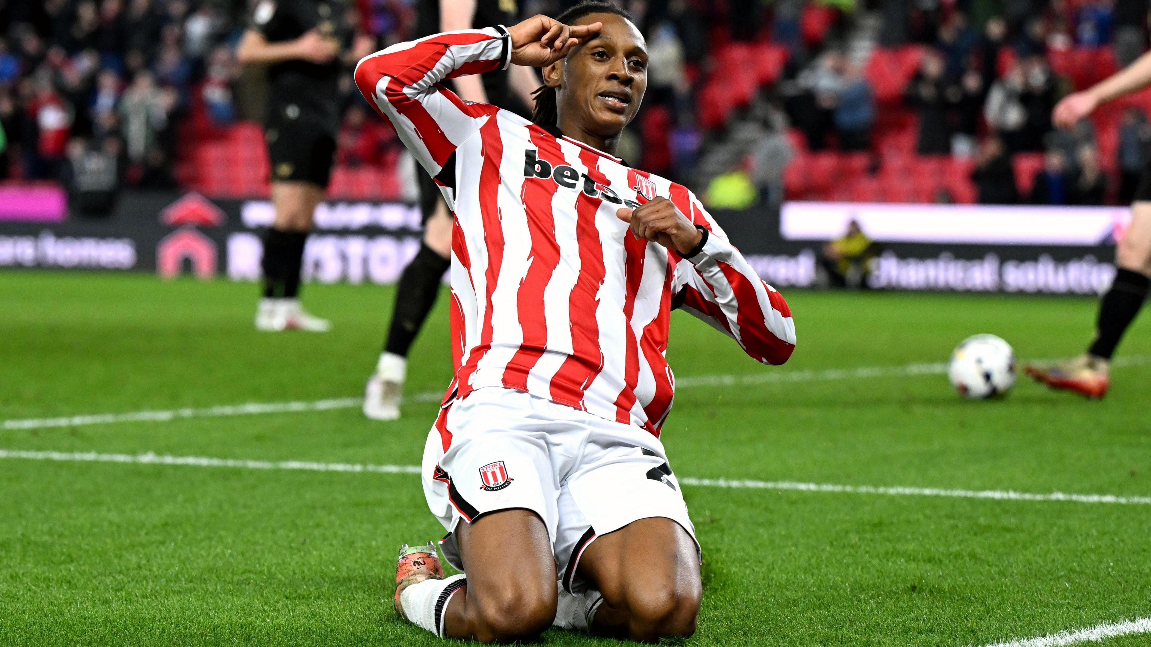 Lamine Cisse slides on his knees and salutes the Stoke City fans