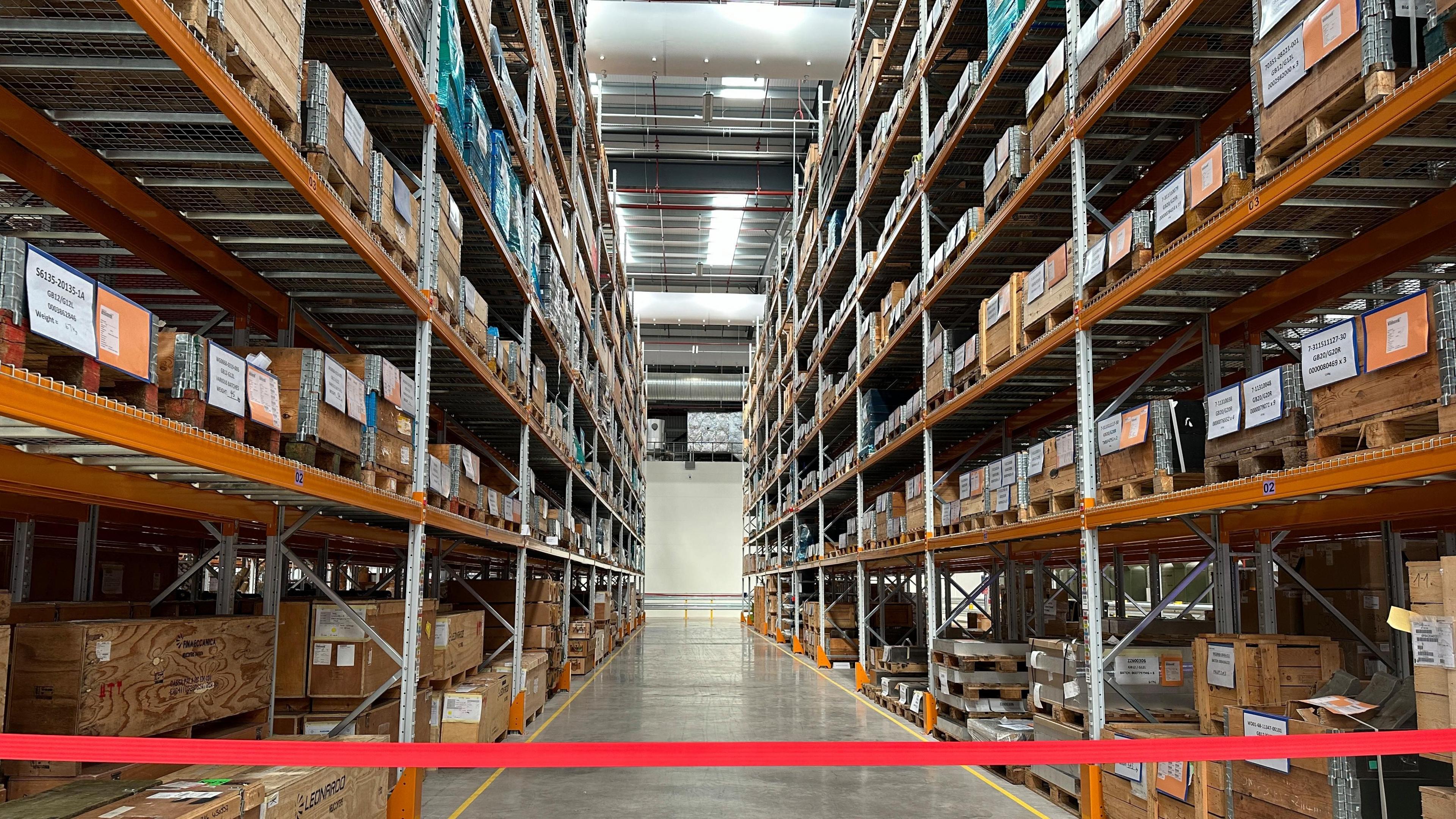 high stacks boxes on shelves in a warehouse