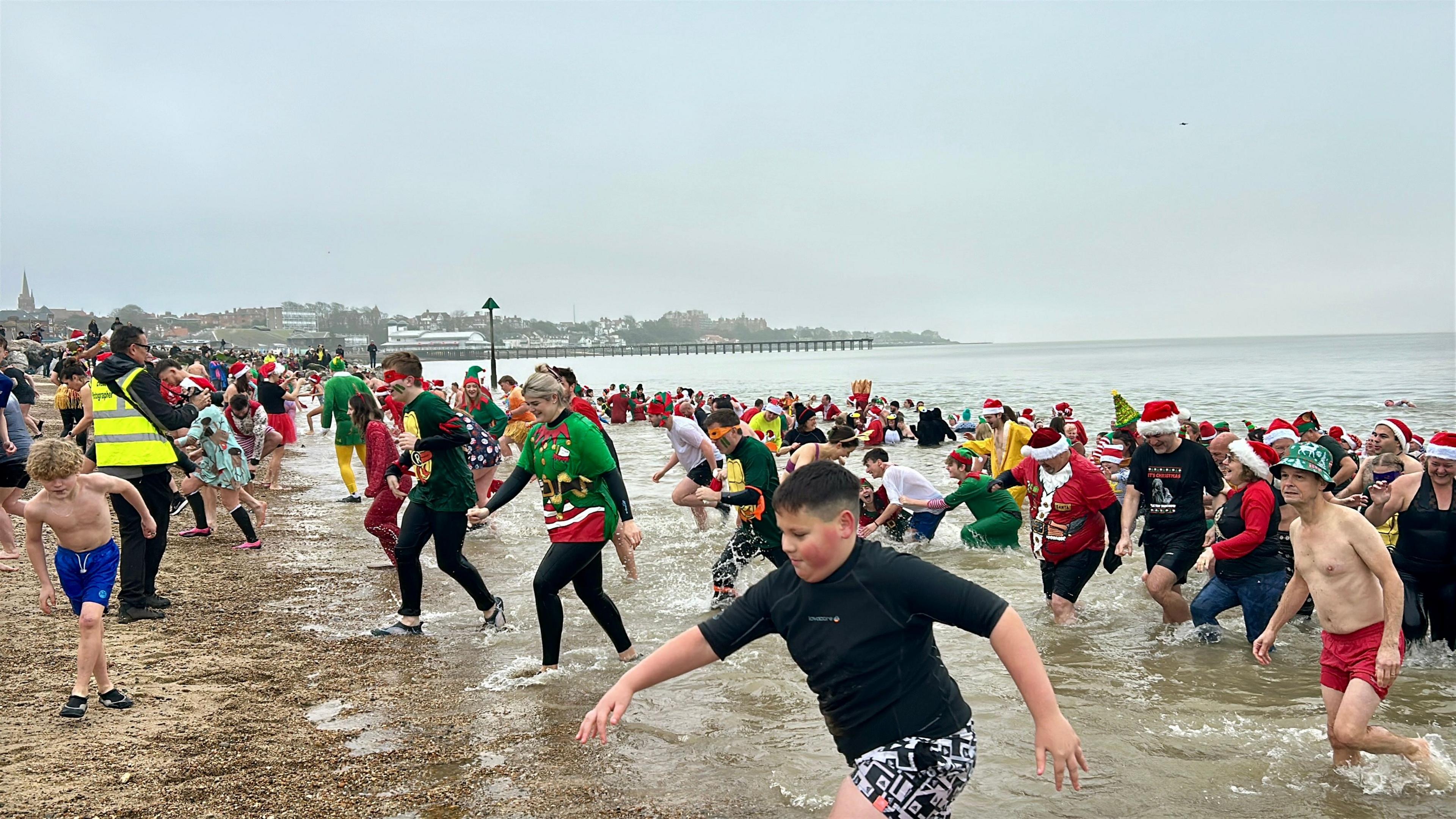 Christmas Day dippers walking out of the sea in Felixstowe