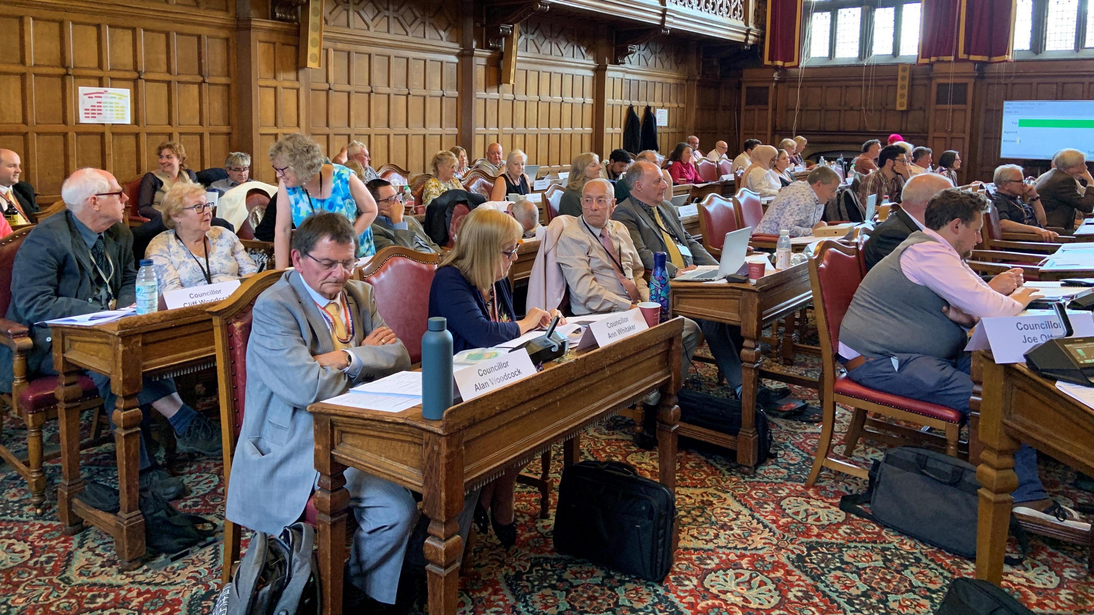 A number of councillors sitting in the council chamber