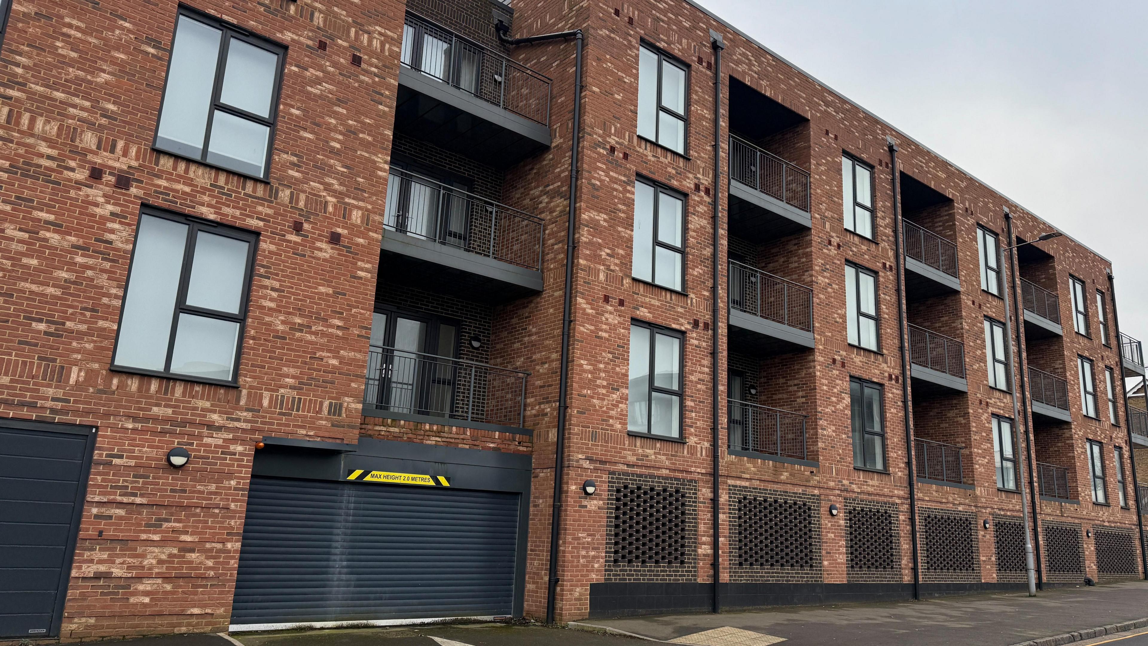 Several windows and balconies are visible at Birch Court across four floors.