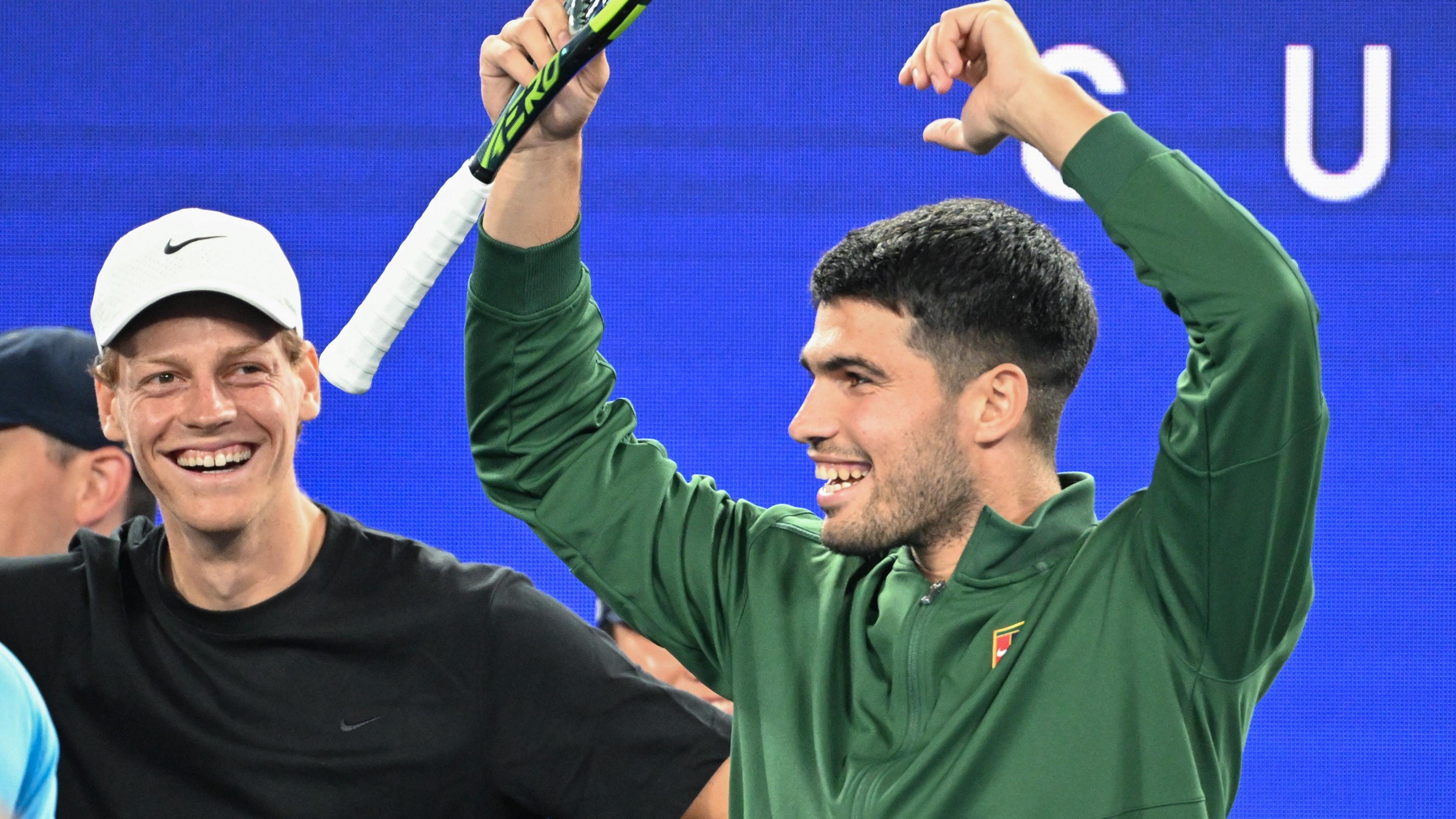Jannik Sinner and Carlos Alcaraz watch on at the Australian Open