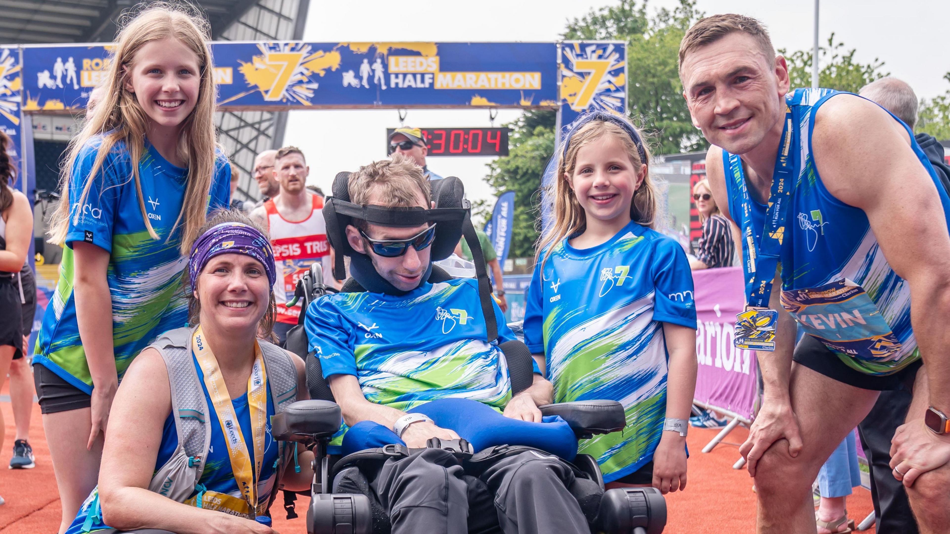 Rob Burrow alongside wife Lindsey (who ran the half marathon), daughters Macy and Maya and Kevin Sinfield who ran the full marathon all pose for a picture after the Rob Burrow Leeds Marathon in 2024.
