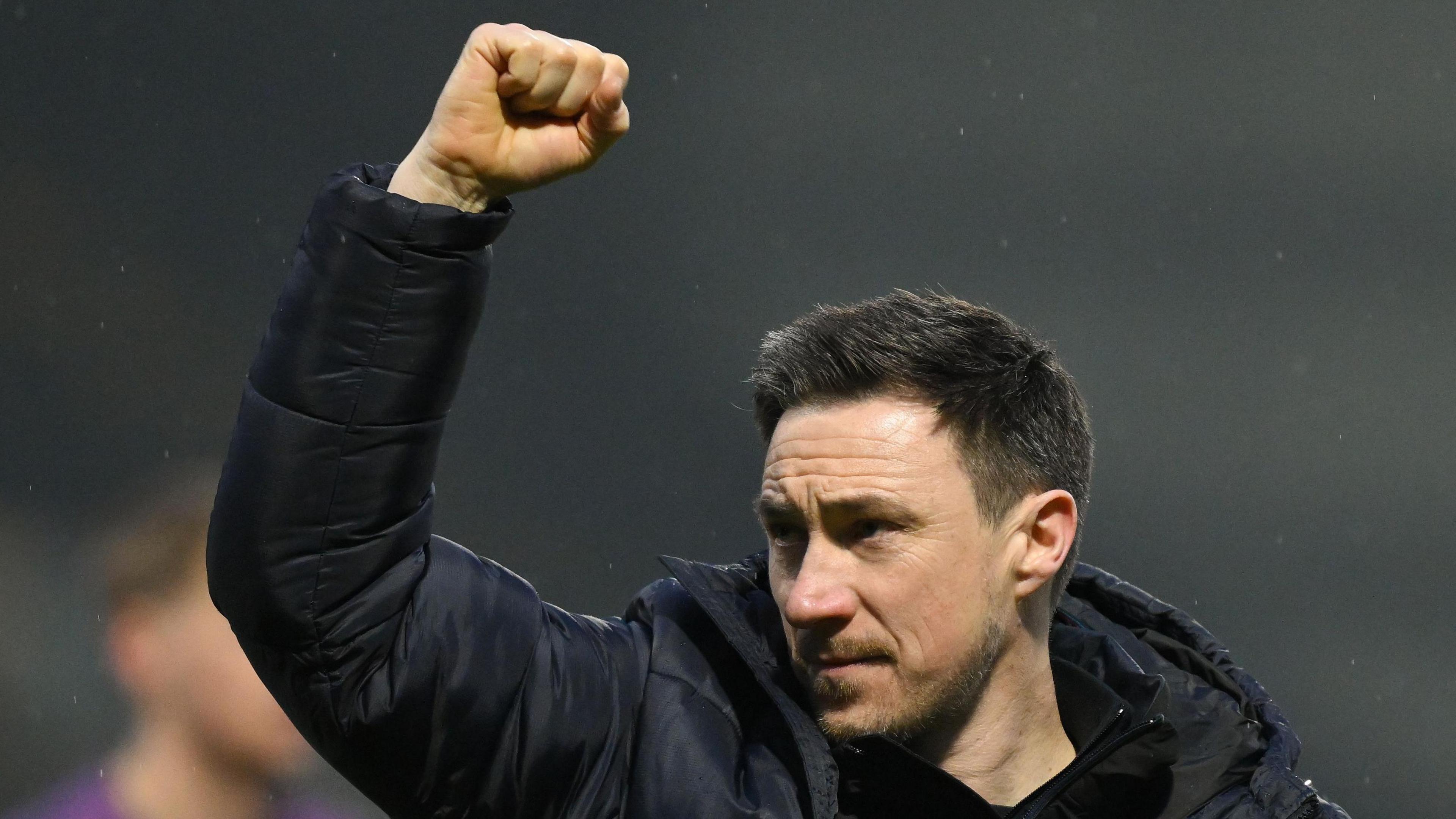 Notts County boss Stuart Maynard throws his fist in the air after his side beat Morecambe